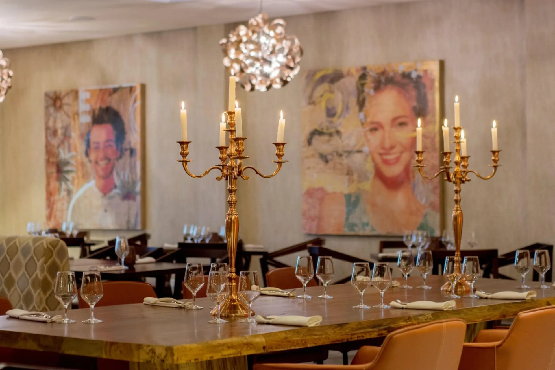 Restaurant table with candelabras and portrait art at Emotions by Hodelpa Puerto Plata.