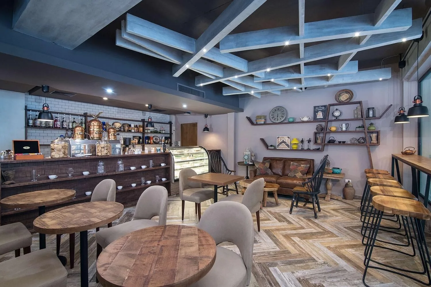 Coffee shop with round tables and pastry case at Emotions by Hodelpa Puerto Plata.