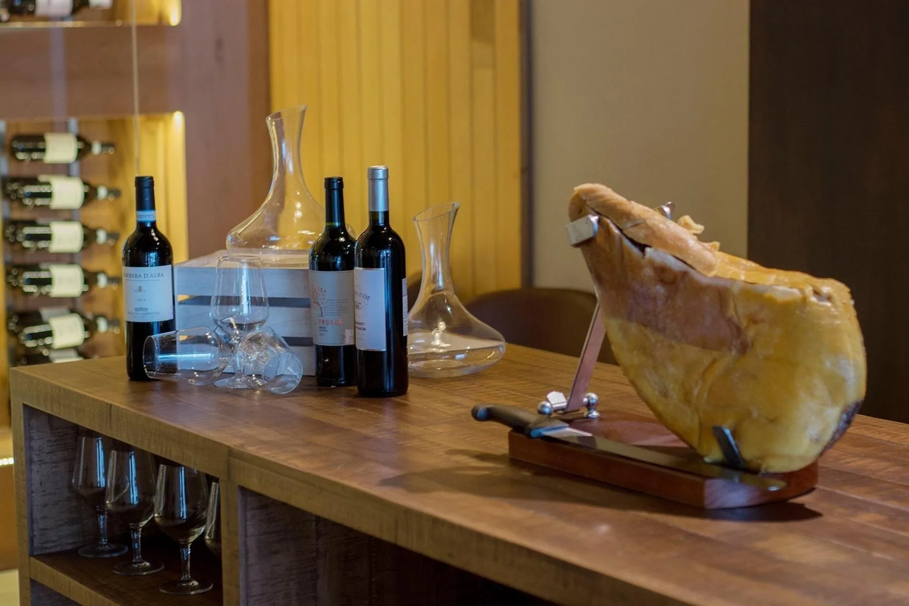 Wine and cheese display on a wooden counter at Emotions by Hodelpa Puerto Plata.