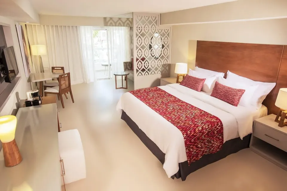 Adults Only Jr. Suite king bed and balcony doors at Emotions by Hodelpa Puerto Plata.