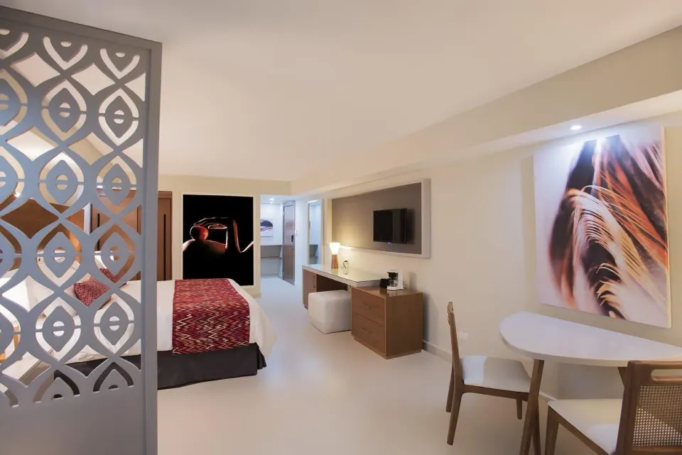 Adults Only Jr. Suite dining table and king bed at Emotions by Hodelpa Puerto Plata.