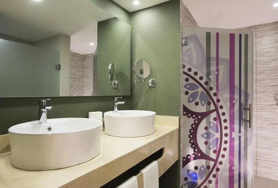 Family Deluxe bathroom with double sinks and shower at Emotions by Hodelpa Puerto Plata.