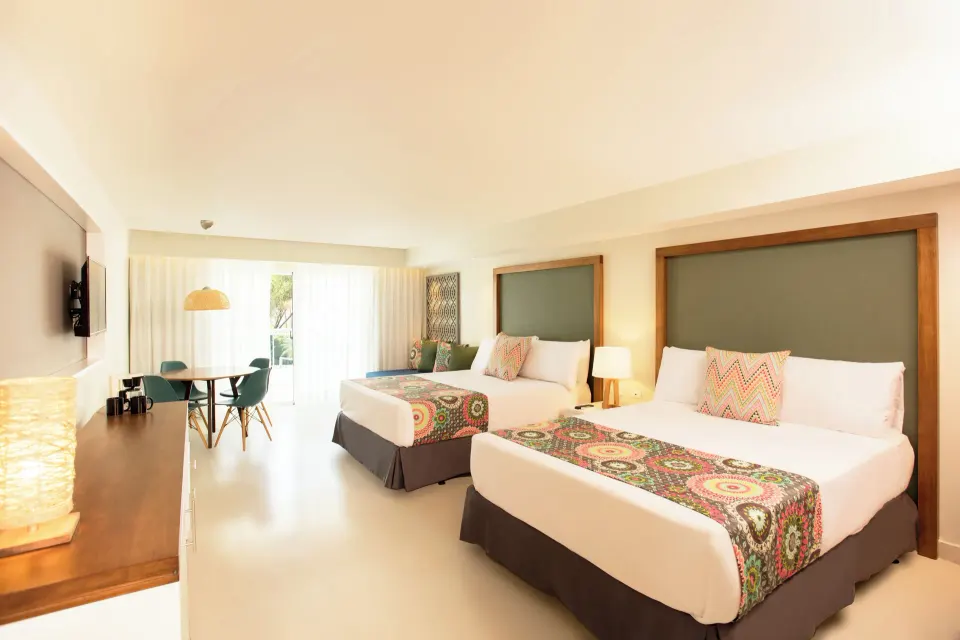 Family Deluxe room with two beds and dining nook at Emotions by Hodelpa Puerto Plata.