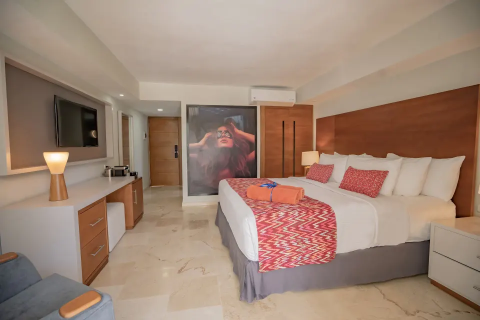 Superior Adults Only king room with TV, desk, and wardrobe at Emotions by Hodelpa Puerto Plata.