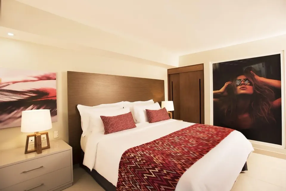 Superior Adults Only king bed with wall art and nightstands at Emotions by Hodelpa Puerto Plata.