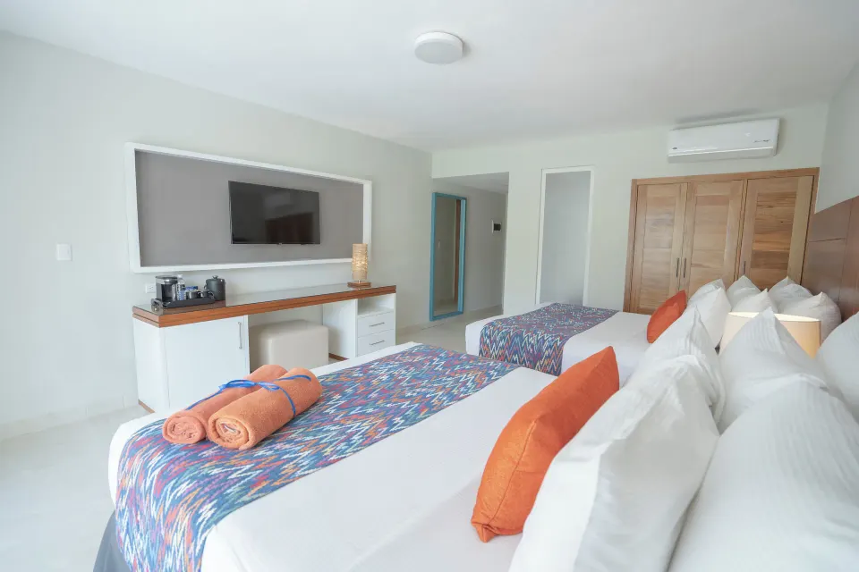 Swim Out Room 18+ two beds and wall-mounted TV at Emotions by Hodelpa Puerto Plata.