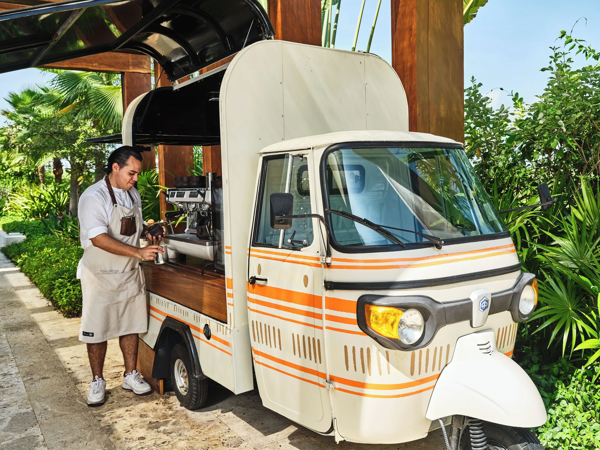 Barista preparing coffee from a small cart at Etéreo, Auberge Collection.
