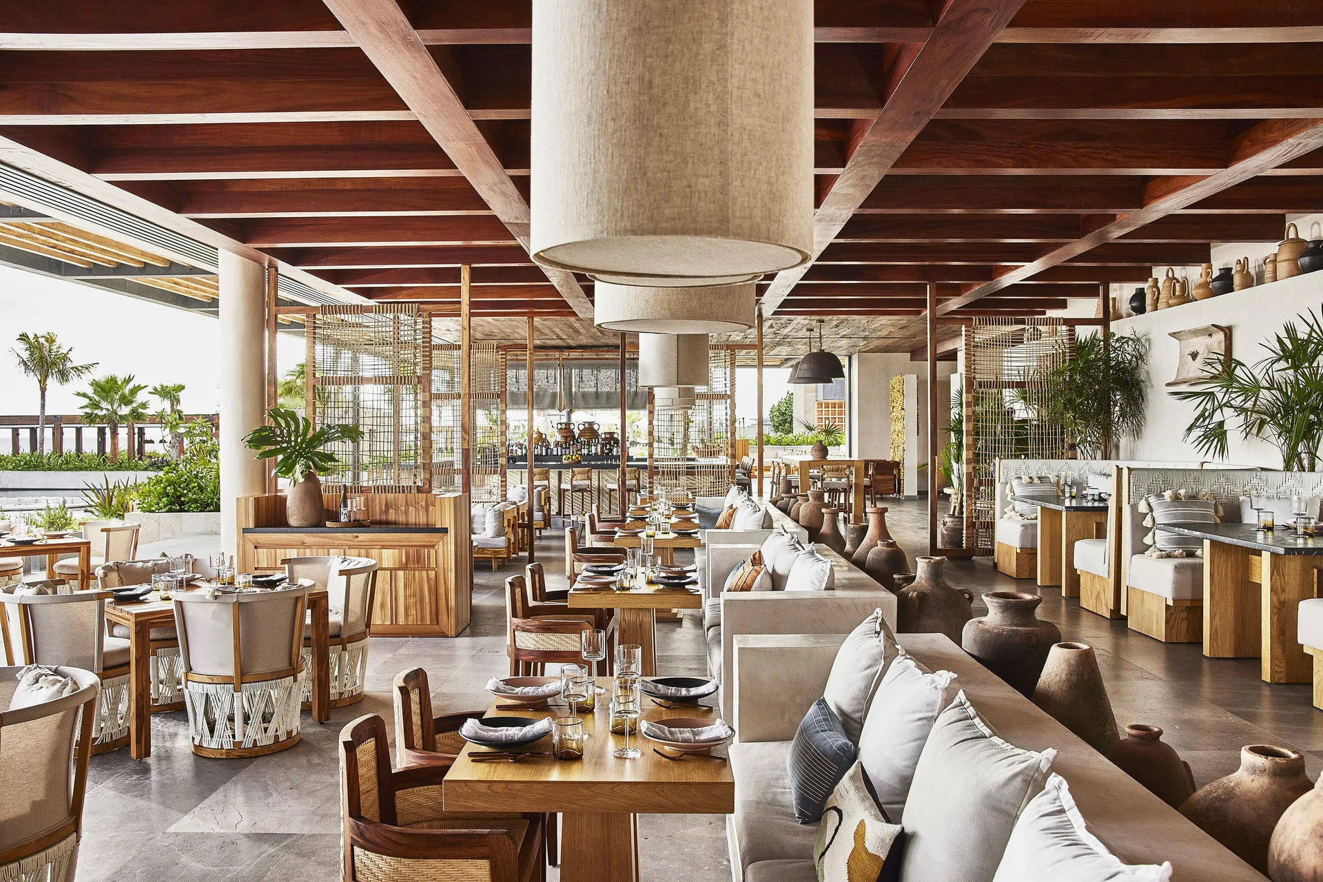 Open-air restaurant dining room with set tables at Etéreo, Auberge Collection.