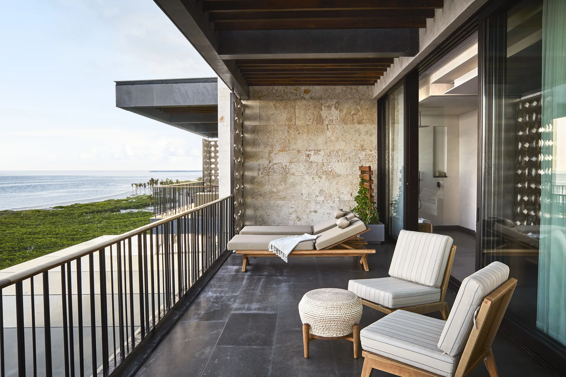 Ocean Studio terrace with lounge seating and sea view at Etéreo, Auberge Collection.