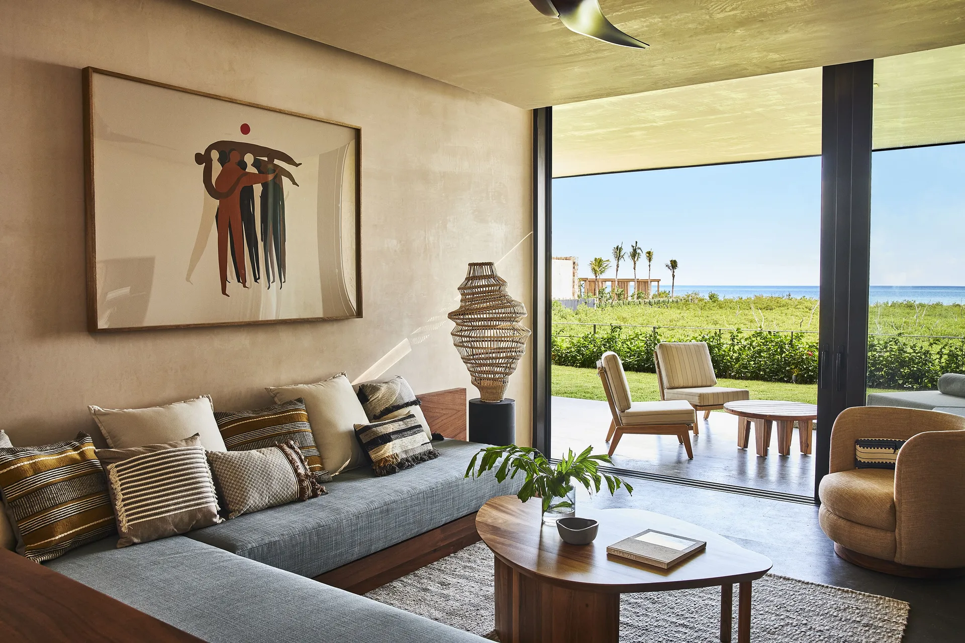 Suite lounge at Etéreo, Auberge Collection opens to a terrace with ocean beyond.