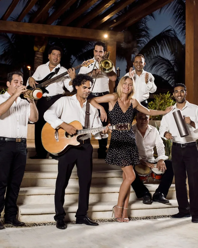 Live band and dancing guest during an evening performance at Excellence Playa Mujeres.