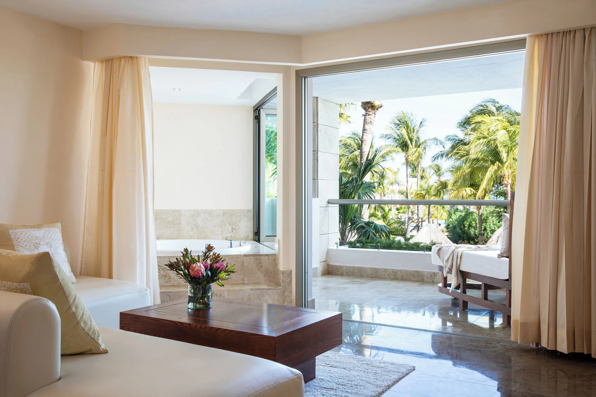 Junior Suite Spa or Pool View seating area opening to a balcony at Excellence Playa Mujeres.
