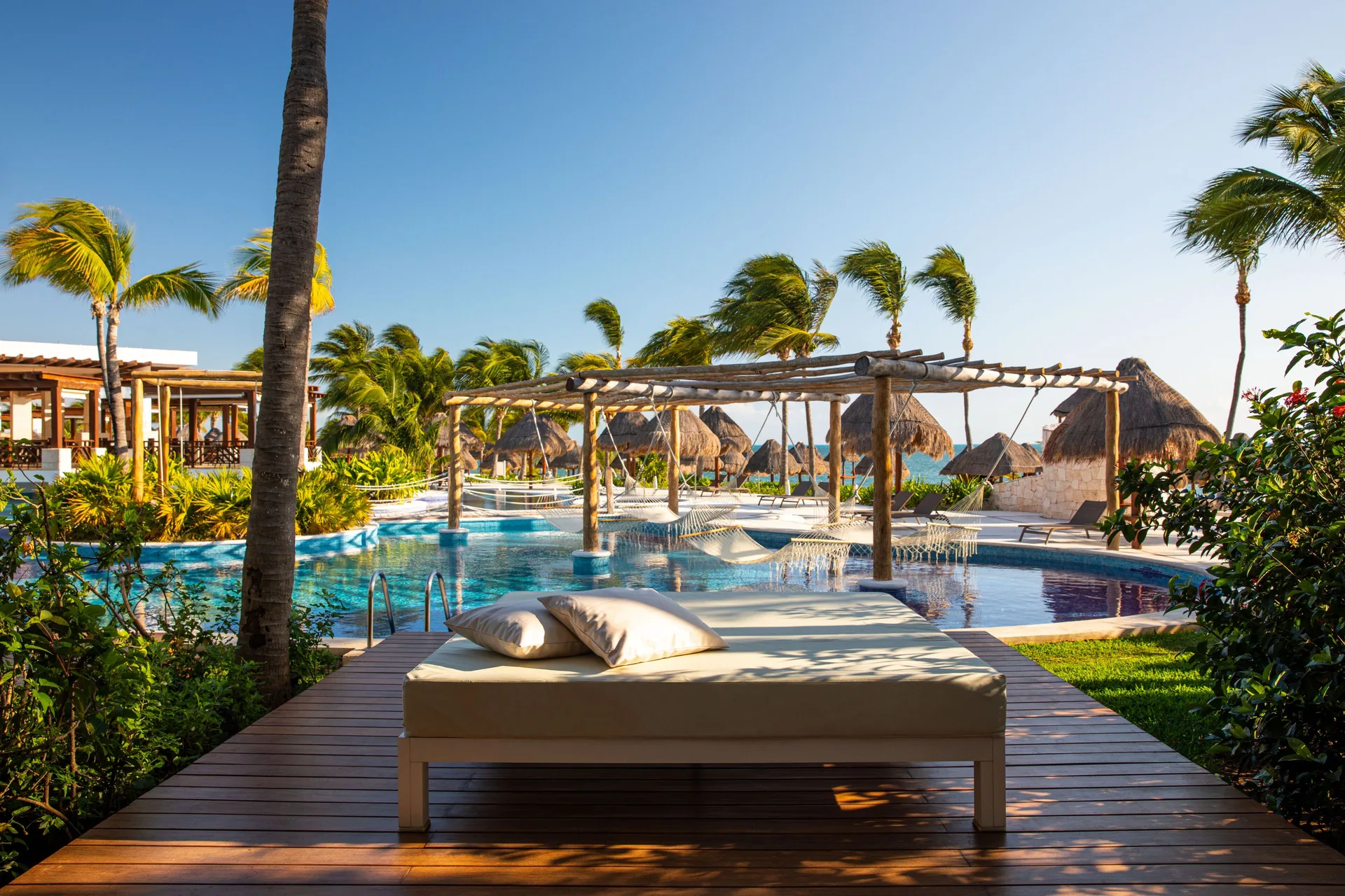 Swim-up suite terrace with daybed and pool at Excellence Playa Mujeres.