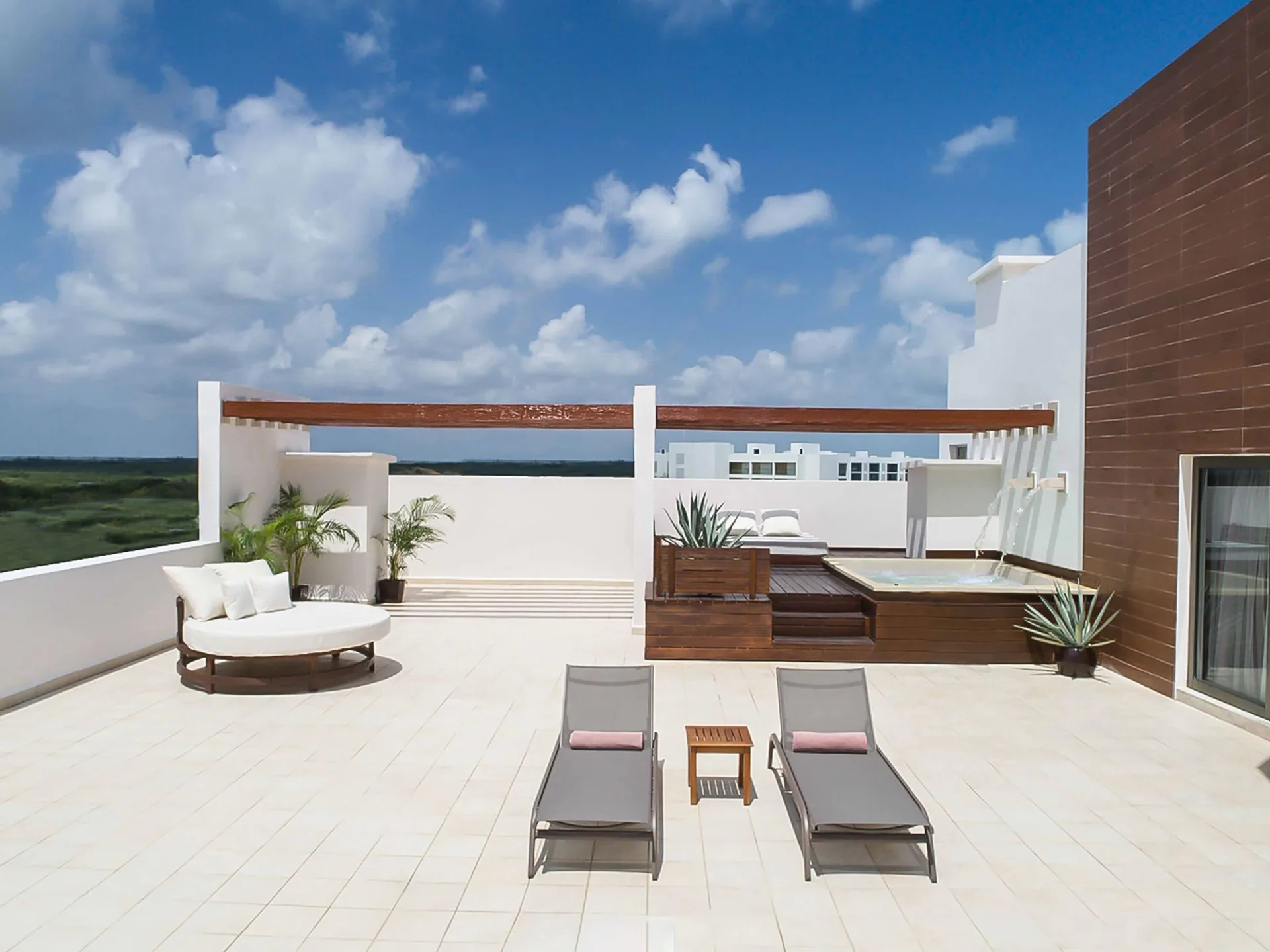 Private terrace with plunge pool, loungers and daybed at Excellence Playa Mujeres.