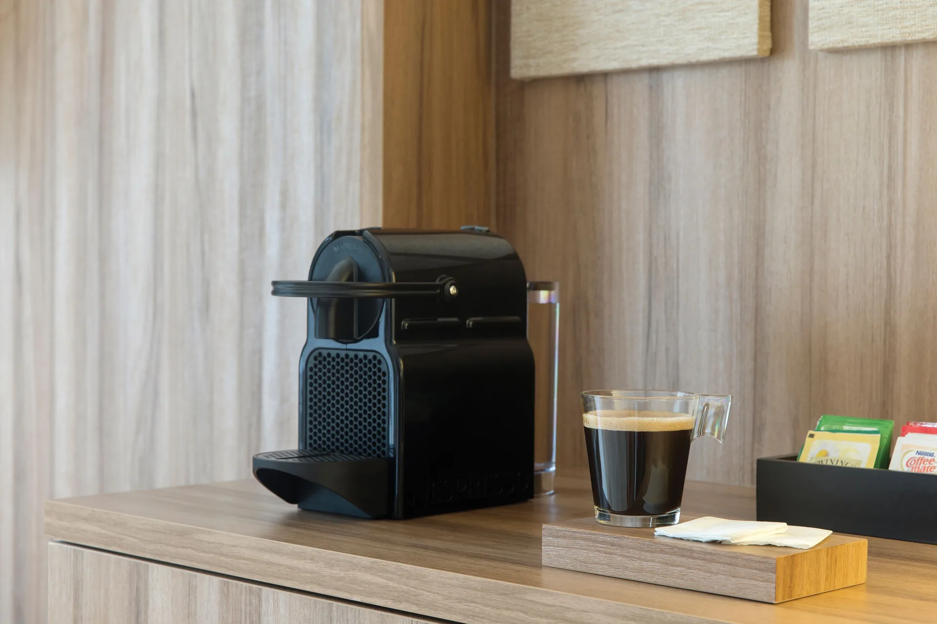 In-room coffee machine with a cup and tea packets in a suite at Excellence Playa Mujeres.