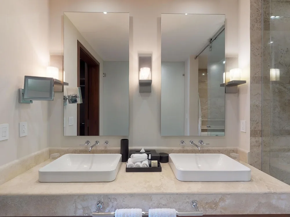 Bathroom vanity with two sinks and mirrors at Fairmont Heritage Place Mayakoba.