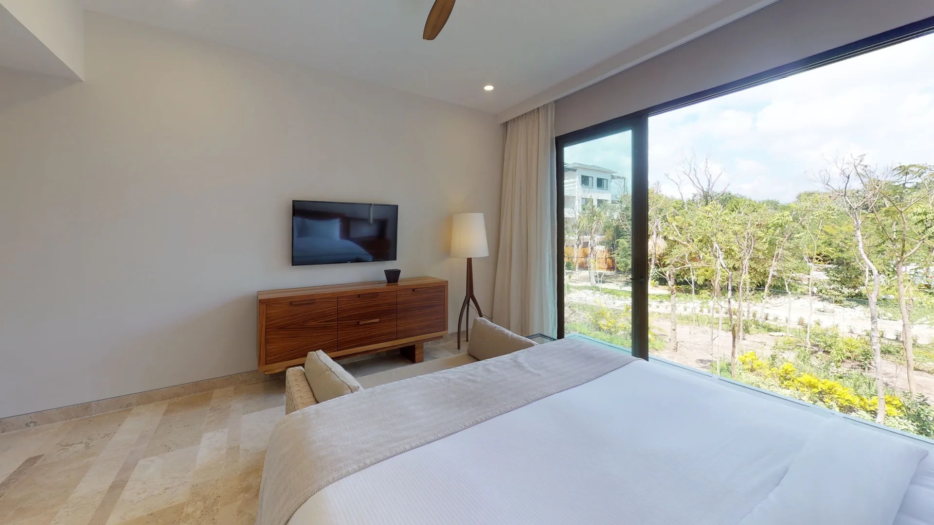 King bedroom with wide garden window at Fairmont Heritage Place Mayakoba.