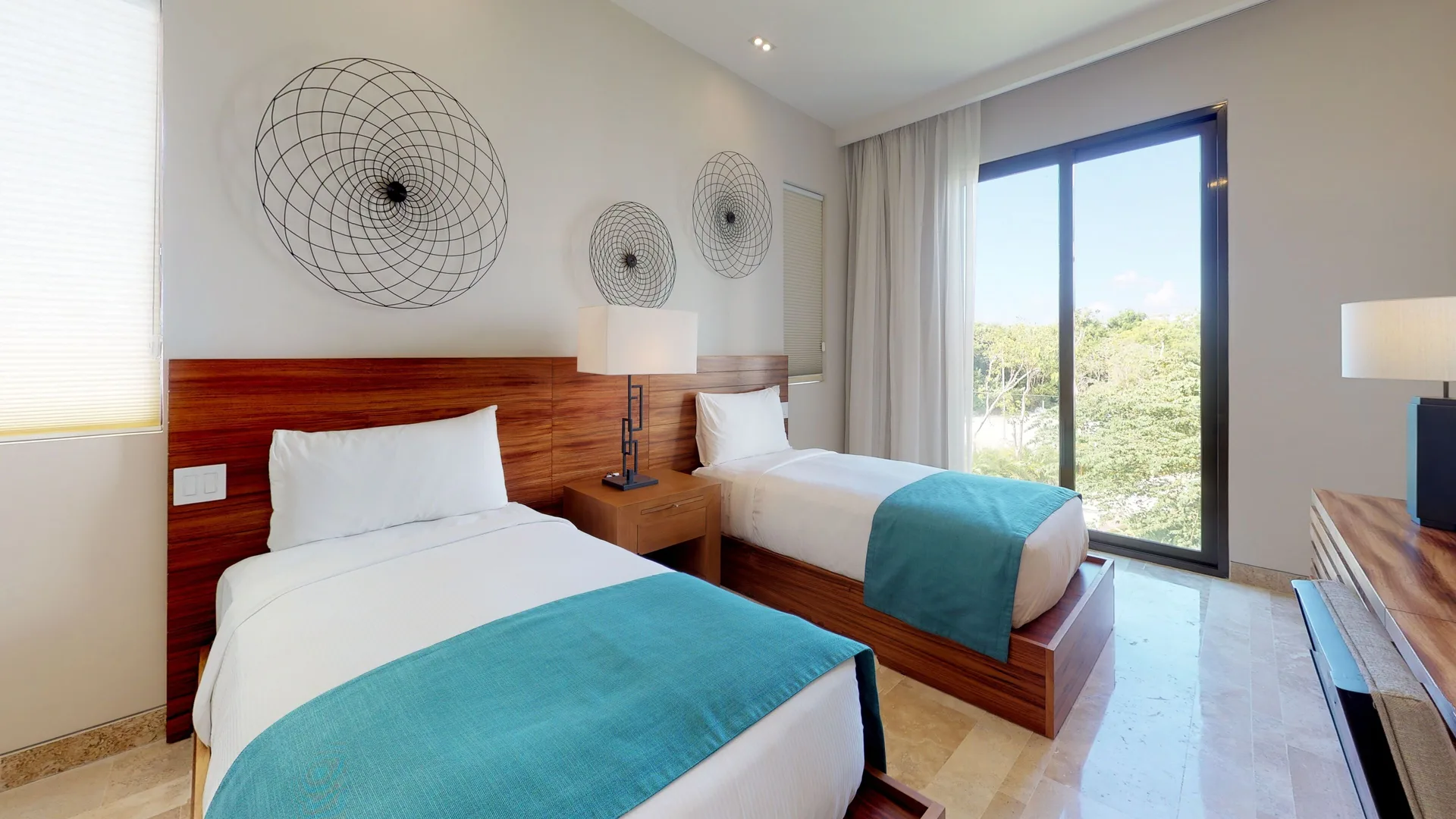 Twin bedroom with turquoise accents at Fairmont Heritage Place Mayakoba.
