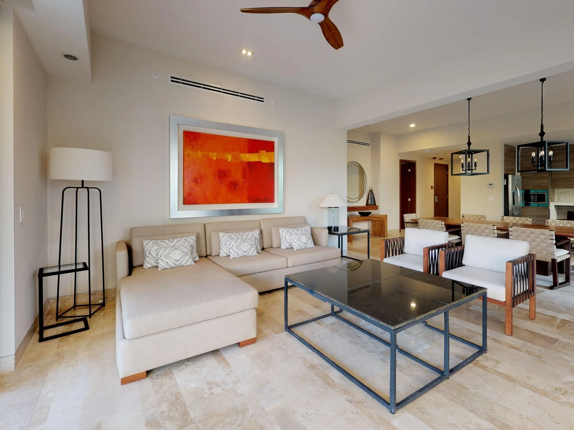 Living room with sectional sofa and dining area at Fairmont Heritage Place Mayakoba.
