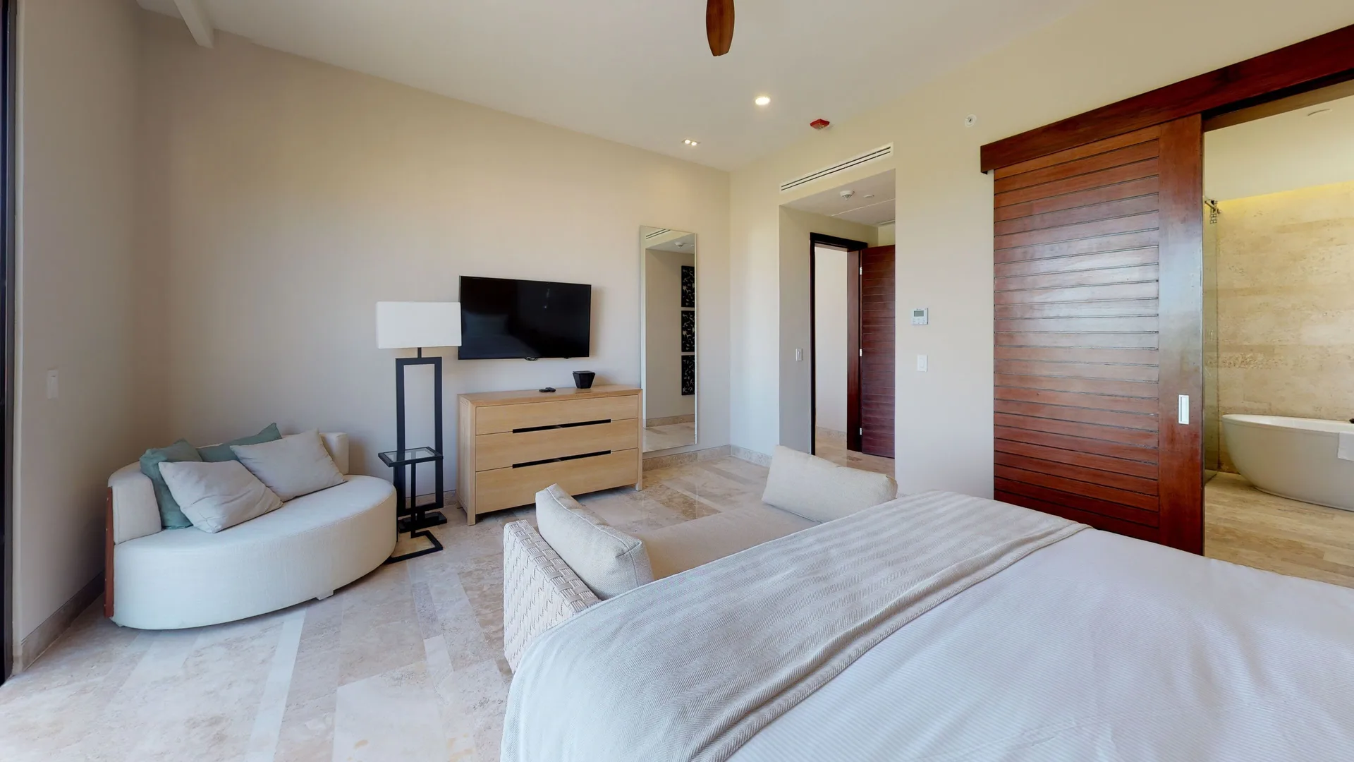 King bedroom with sitting area and bathroom view at Fairmont Heritage Place Mayakoba.