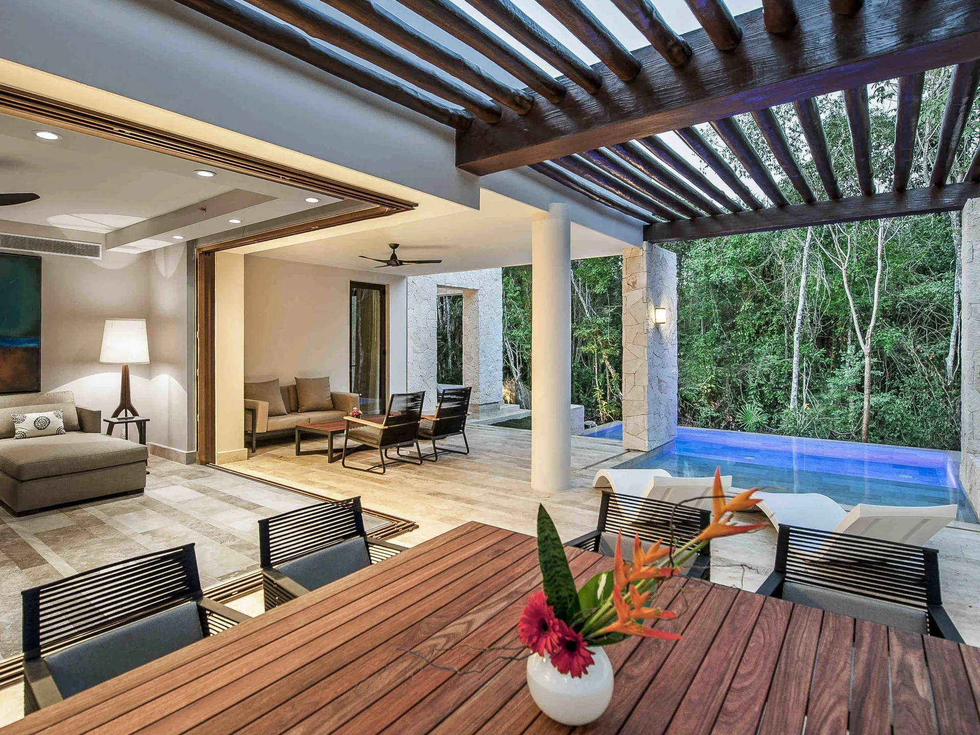 Covered terrace with dining table and plunge pool at Fairmont Heritage Place Mayakoba.