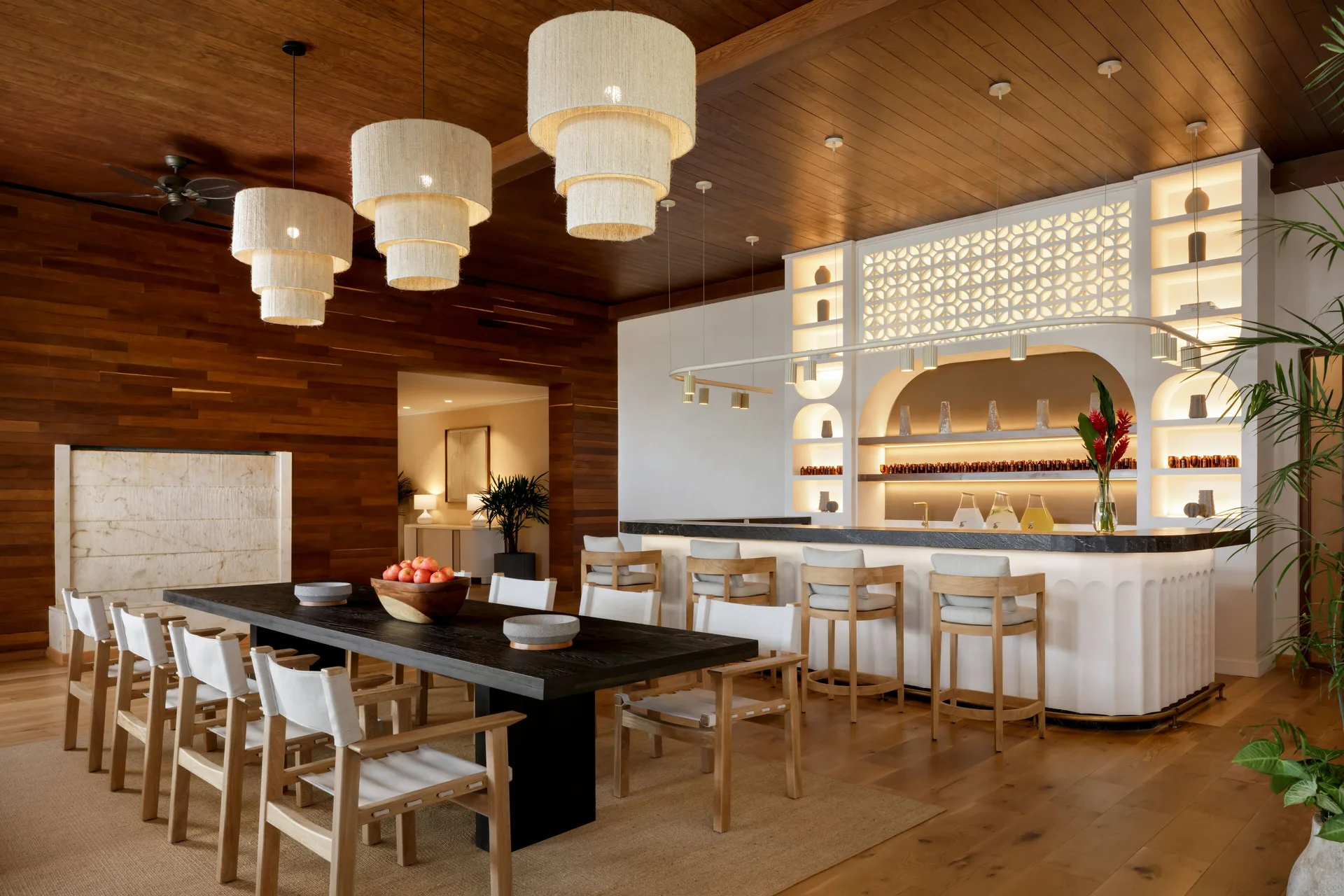 Dining table and bar counter in a wood-paneled room at Fairmont Heritage Place Mayakoba.