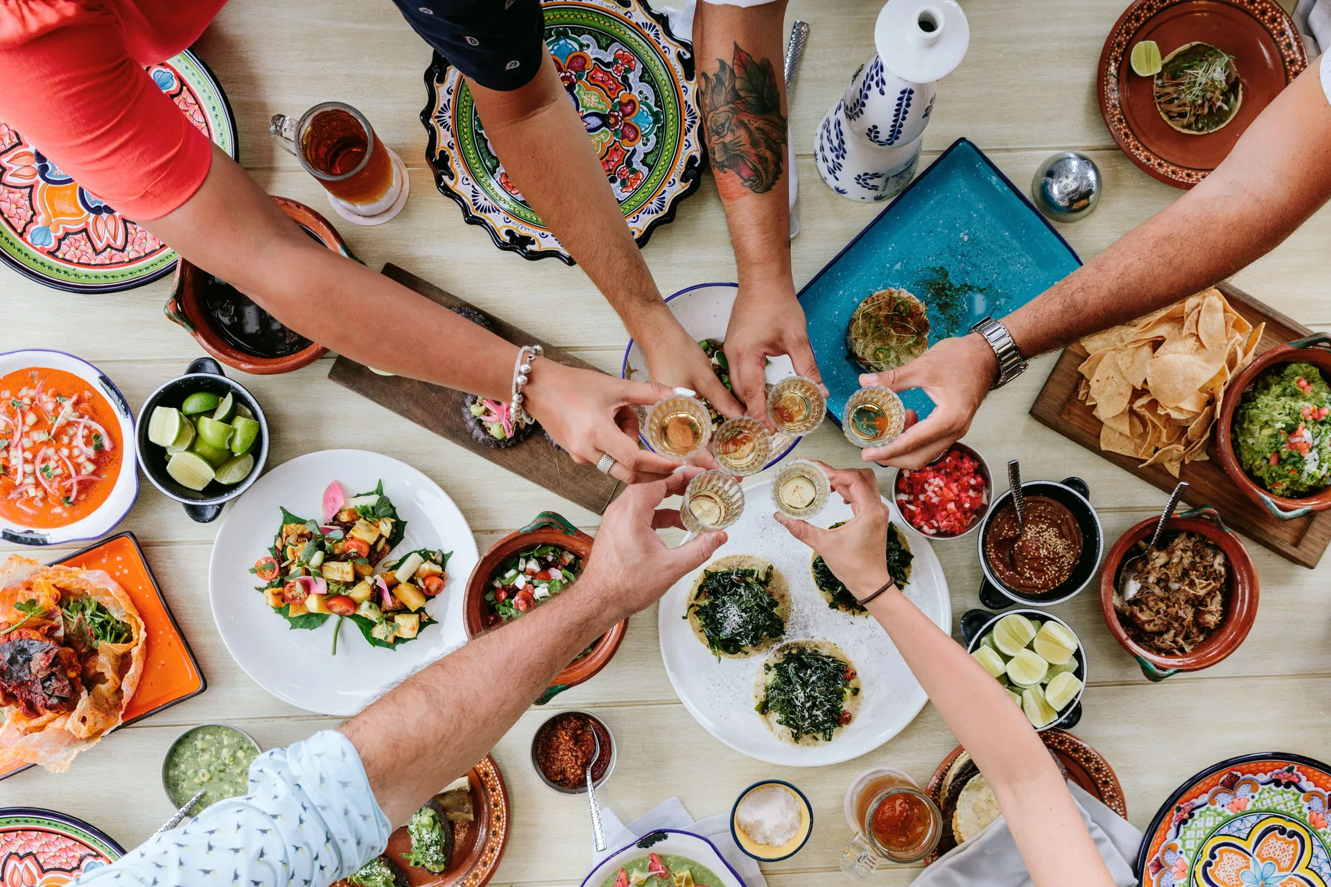 Overhead Mexican meal with shared drinks at Fairmont Heritage Place Mayakoba.
