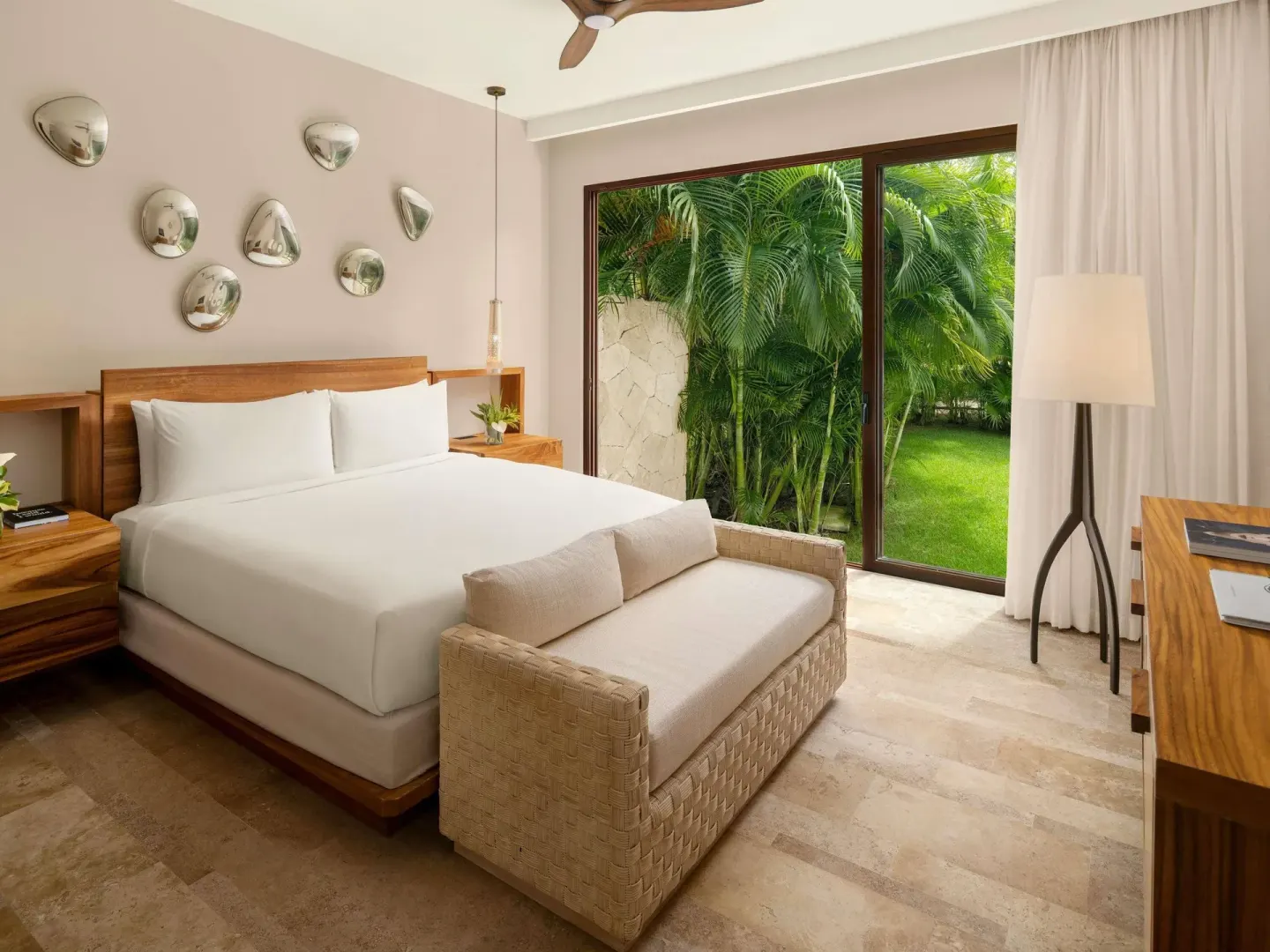 King bedroom with garden-facing glass doors at Fairmont Heritage Place Mayakoba.