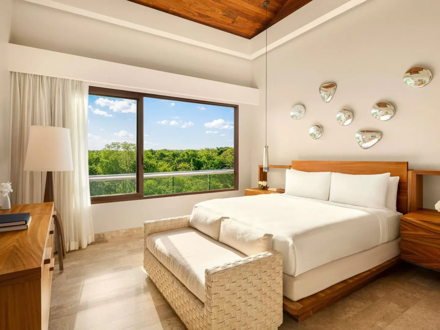 King bedroom with large window and treetop view at Fairmont Heritage Place Mayakoba.