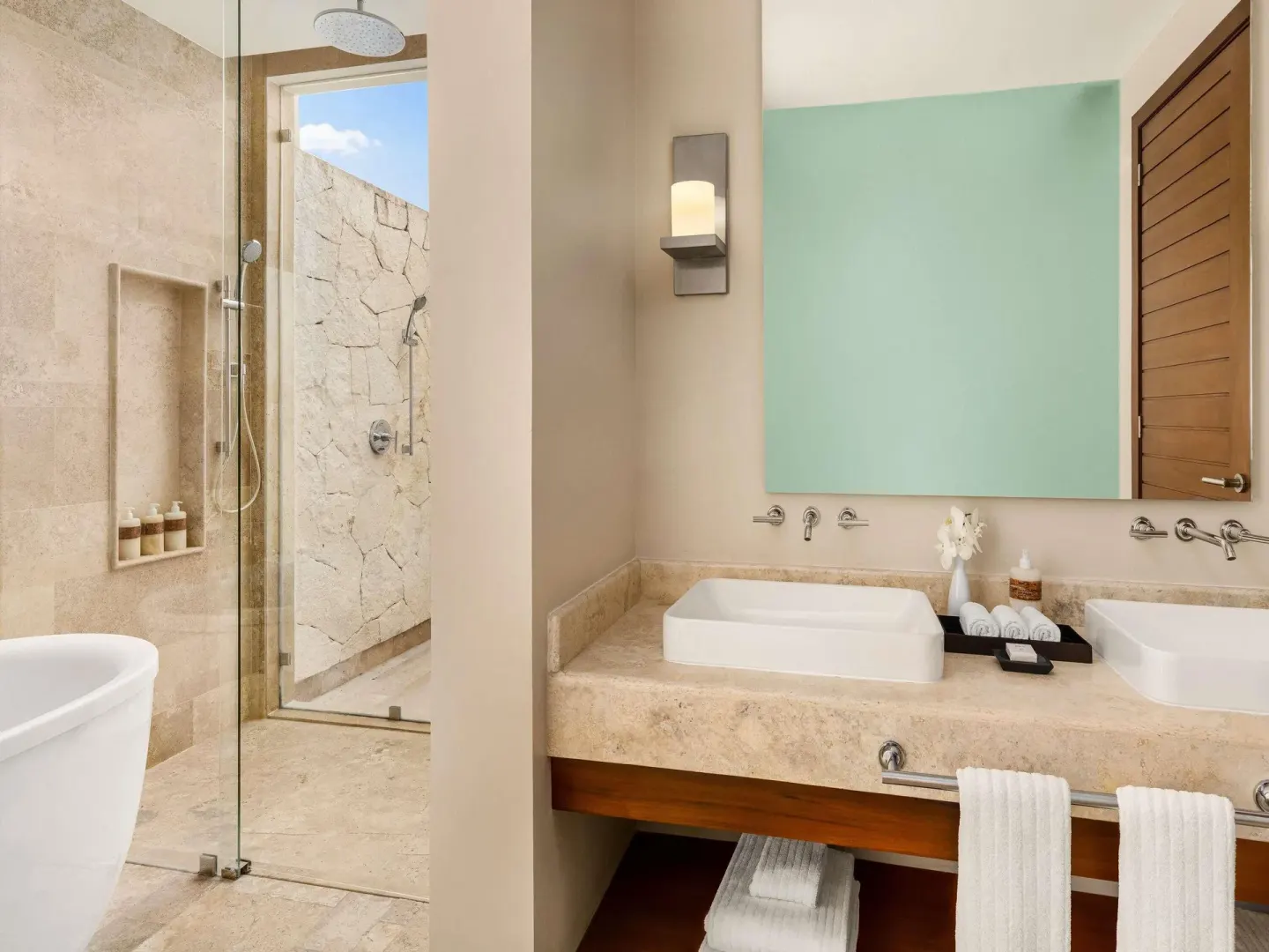Bathroom with double vanity and glass shower at Fairmont Heritage Place Mayakoba.