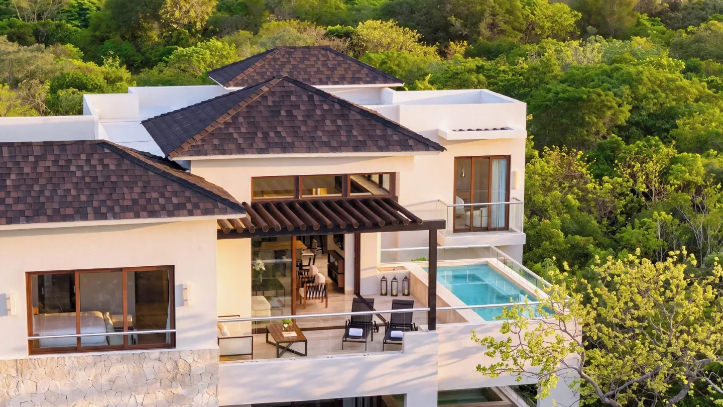 Penthouse villa exterior with balcony and pool at Fairmont Heritage Place Mayakoba.