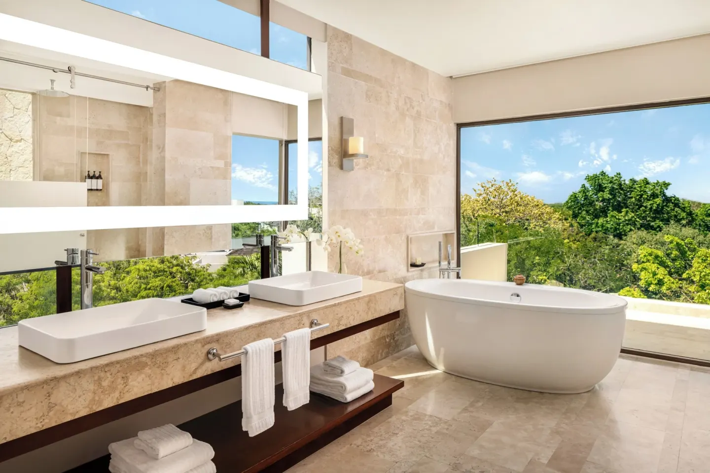 Bathroom with double vanity and freestanding tub in a penthouse villa at Fairmont Heritage Place Mayakoba.