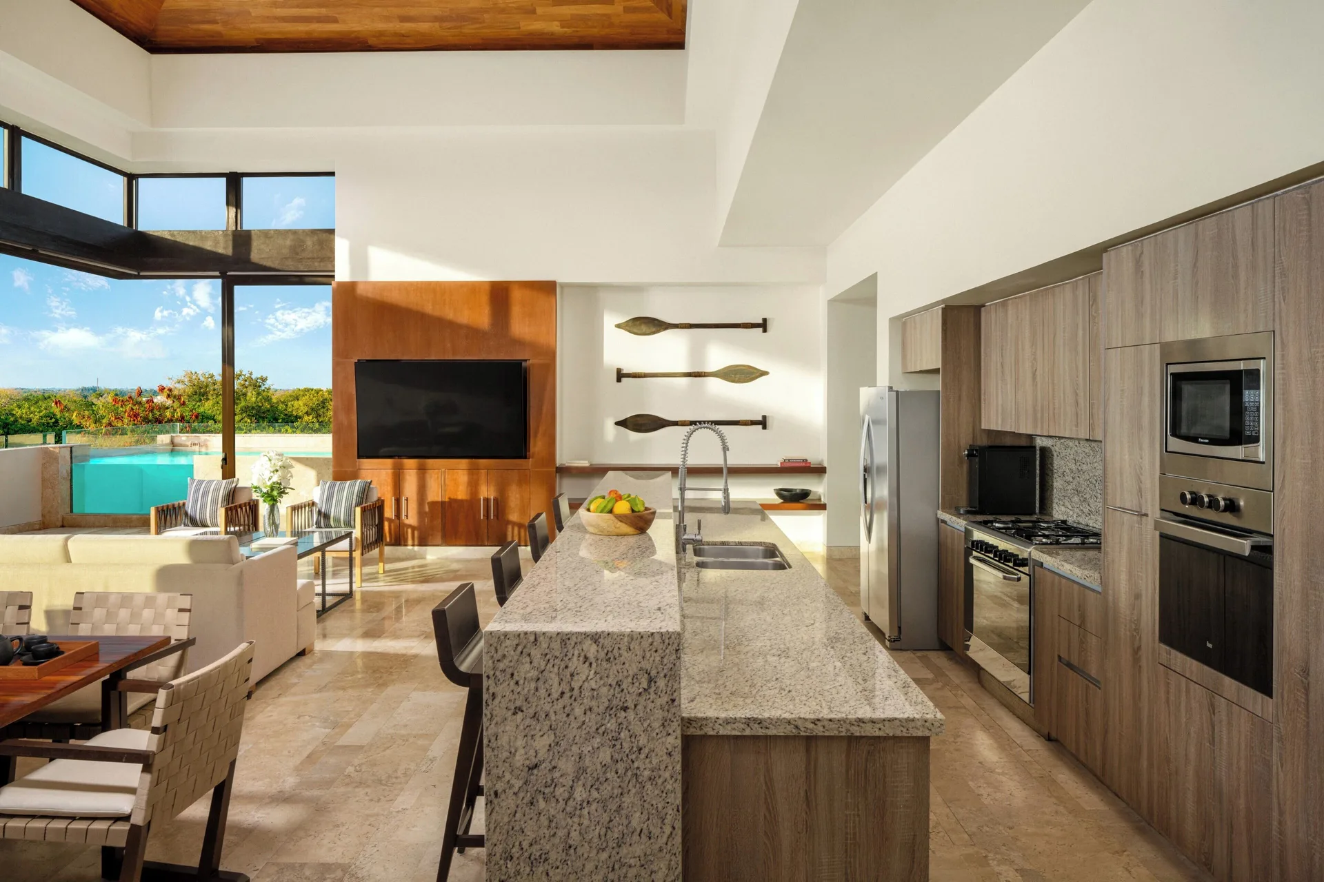 Kitchen and open living area in a four-bedroom penthouse villa at Fairmont Heritage Place Mayakoba.