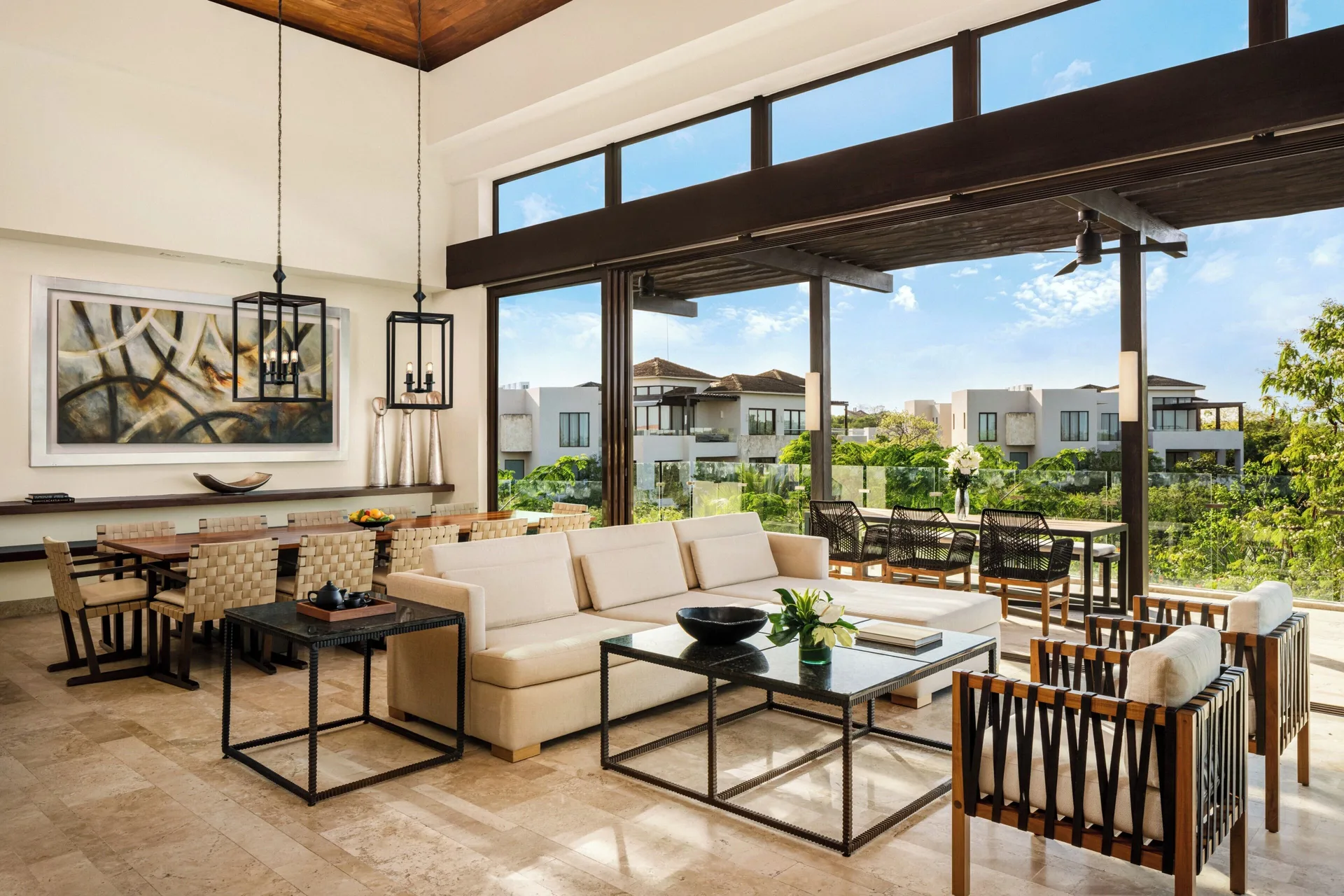 Open living and dining area in a four-bedroom penthouse villa at Fairmont Heritage Place Mayakoba.
