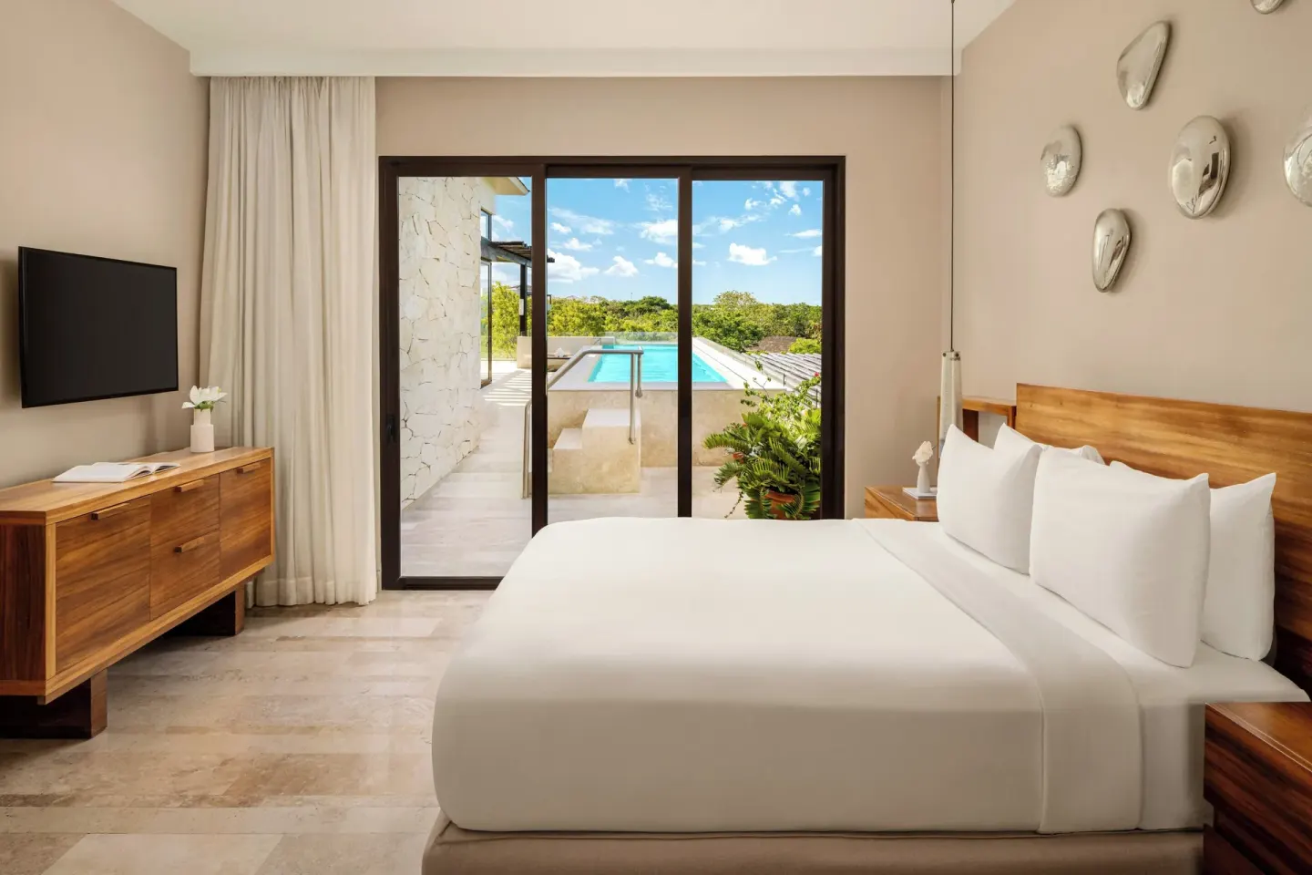 King bedroom opening to a terrace pool in a penthouse villa at Fairmont Heritage Place Mayakoba.