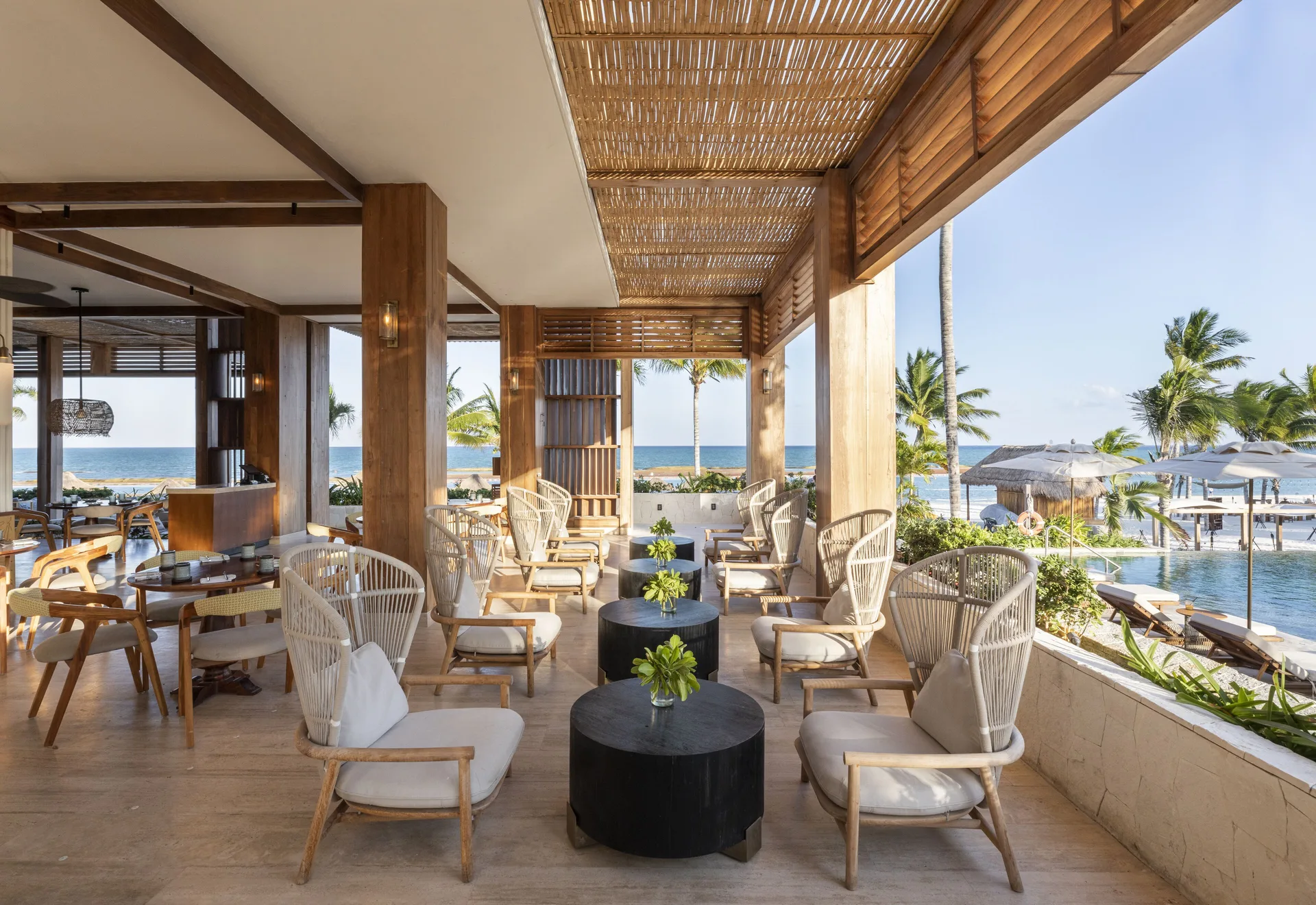 Open-air beachside lounge with pool and ocean views at Fairmont Mayakoba.