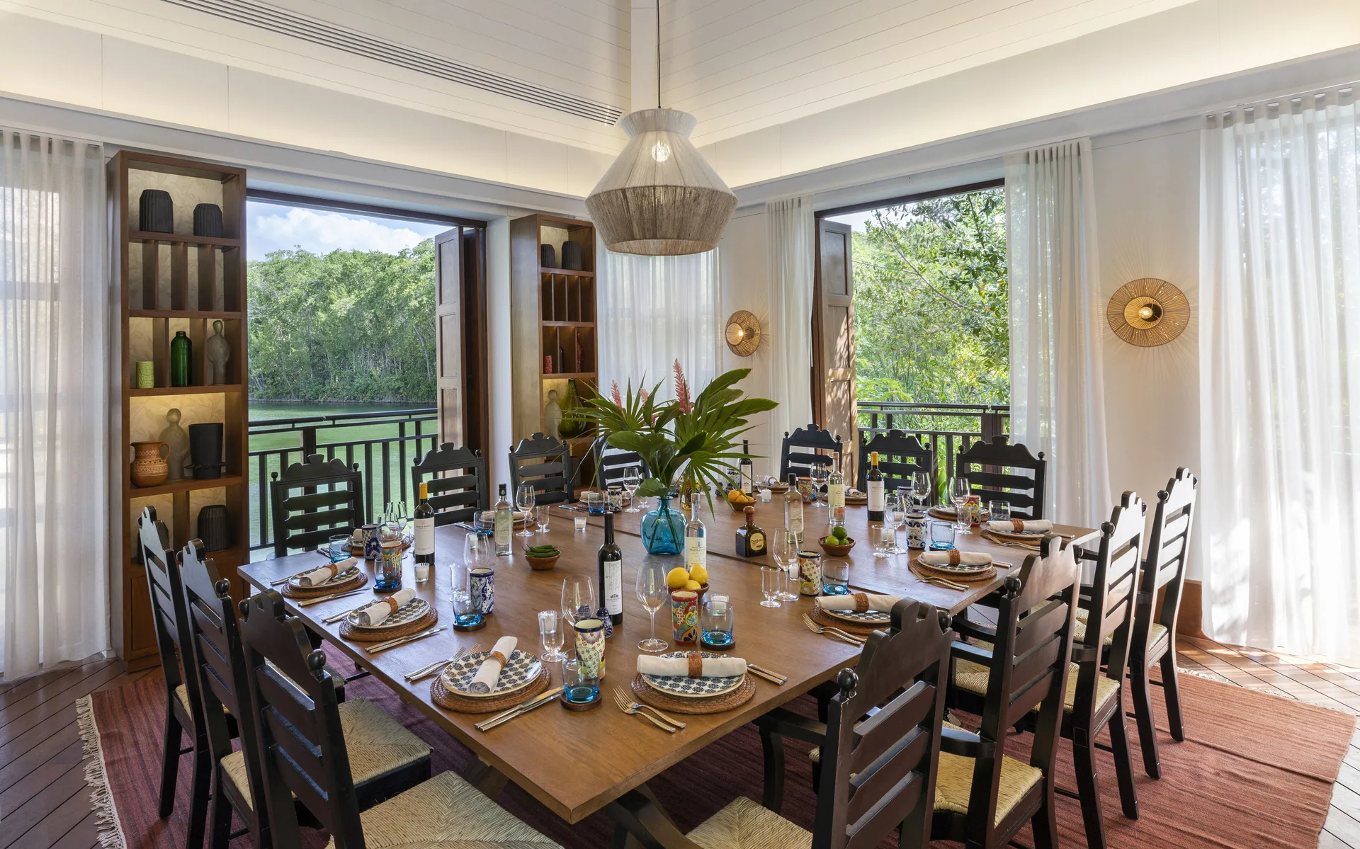 Private dining table set beside lagoon-facing windows at Fairmont Mayakoba.