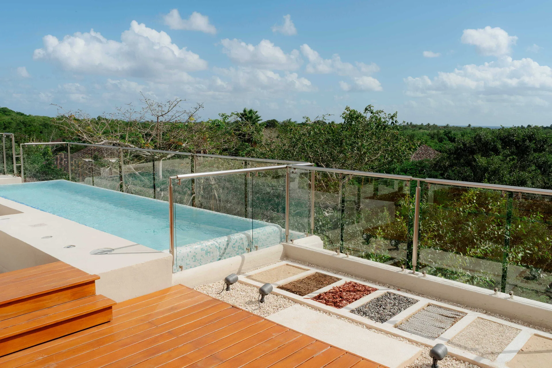Bambu Suite private pool edge and glass railing overlooking greenery at Fairmont Mayakoba.