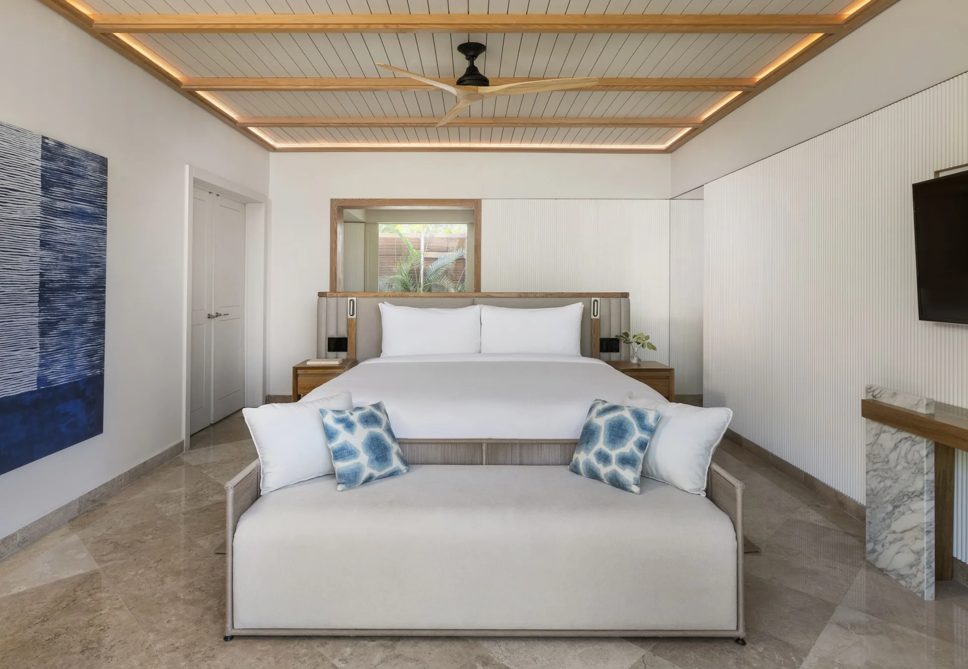Beach Area Casita Suite king bedroom at Fairmont Mayakoba with sofa and wall-mounted TV.