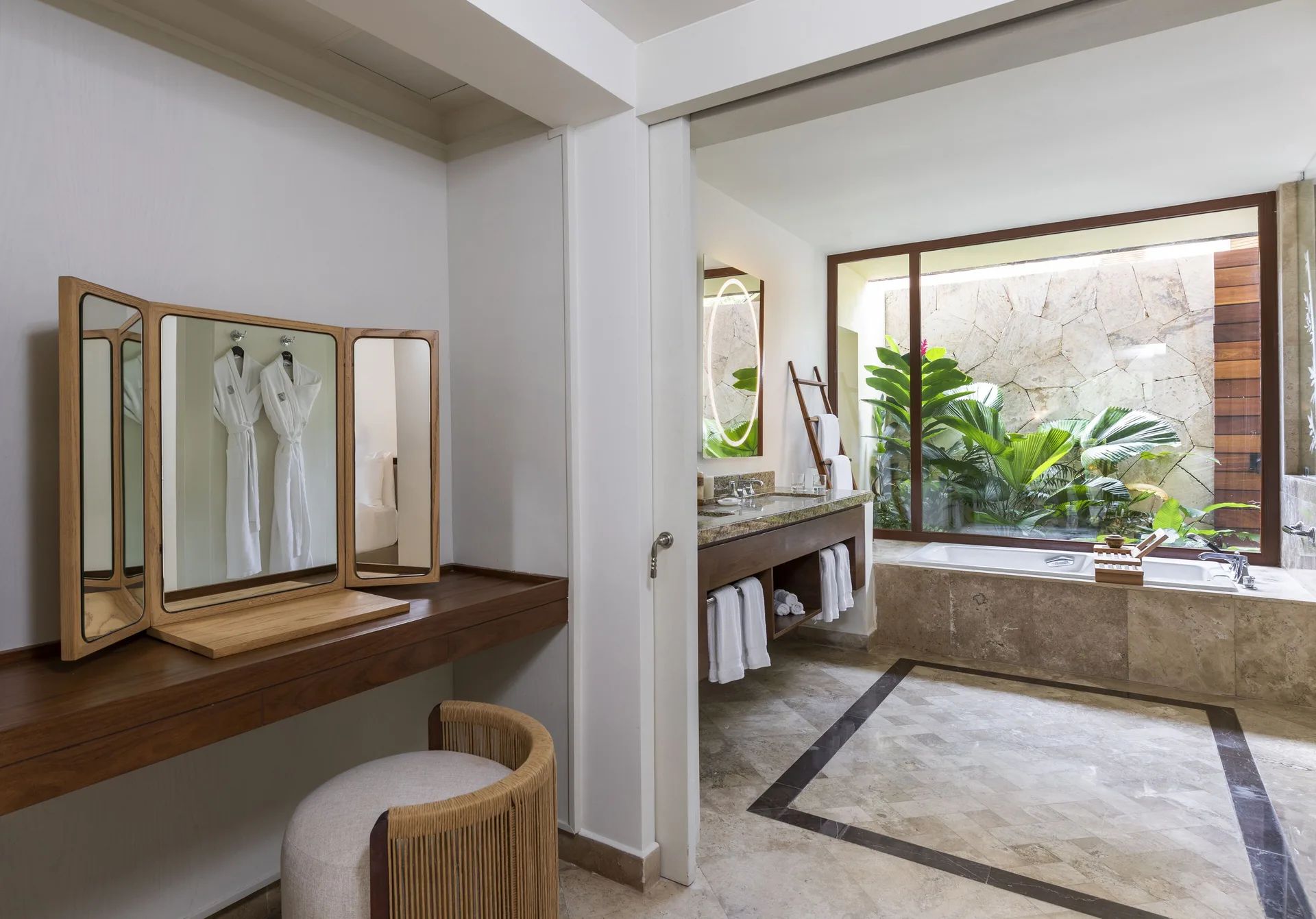 Casita Signature suite bathroom with vanity, tub, and dressing area at Fairmont Mayakoba.