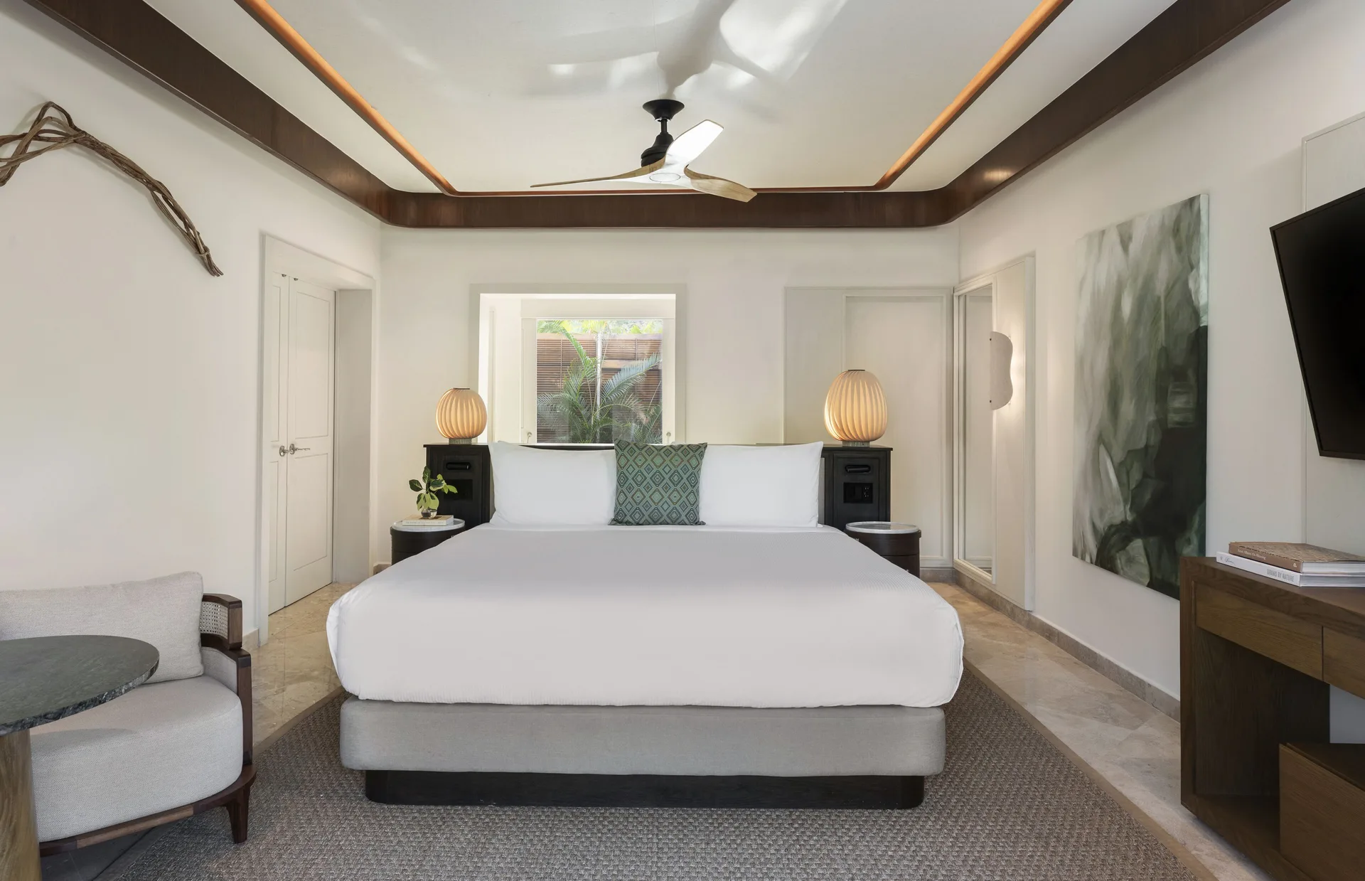 Casita Signature suite bedroom with king bed and seating at Fairmont Mayakoba.
