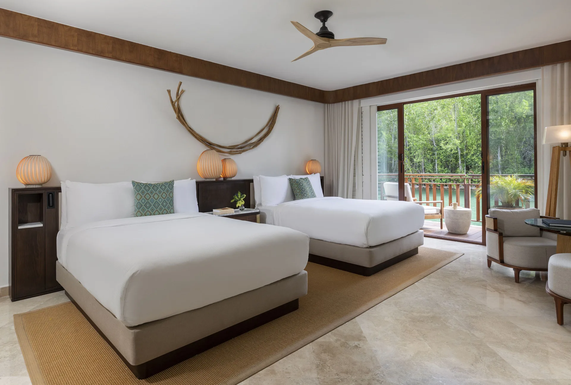 Casita Signature suite bedroom with two beds and balcony at Fairmont Mayakoba.