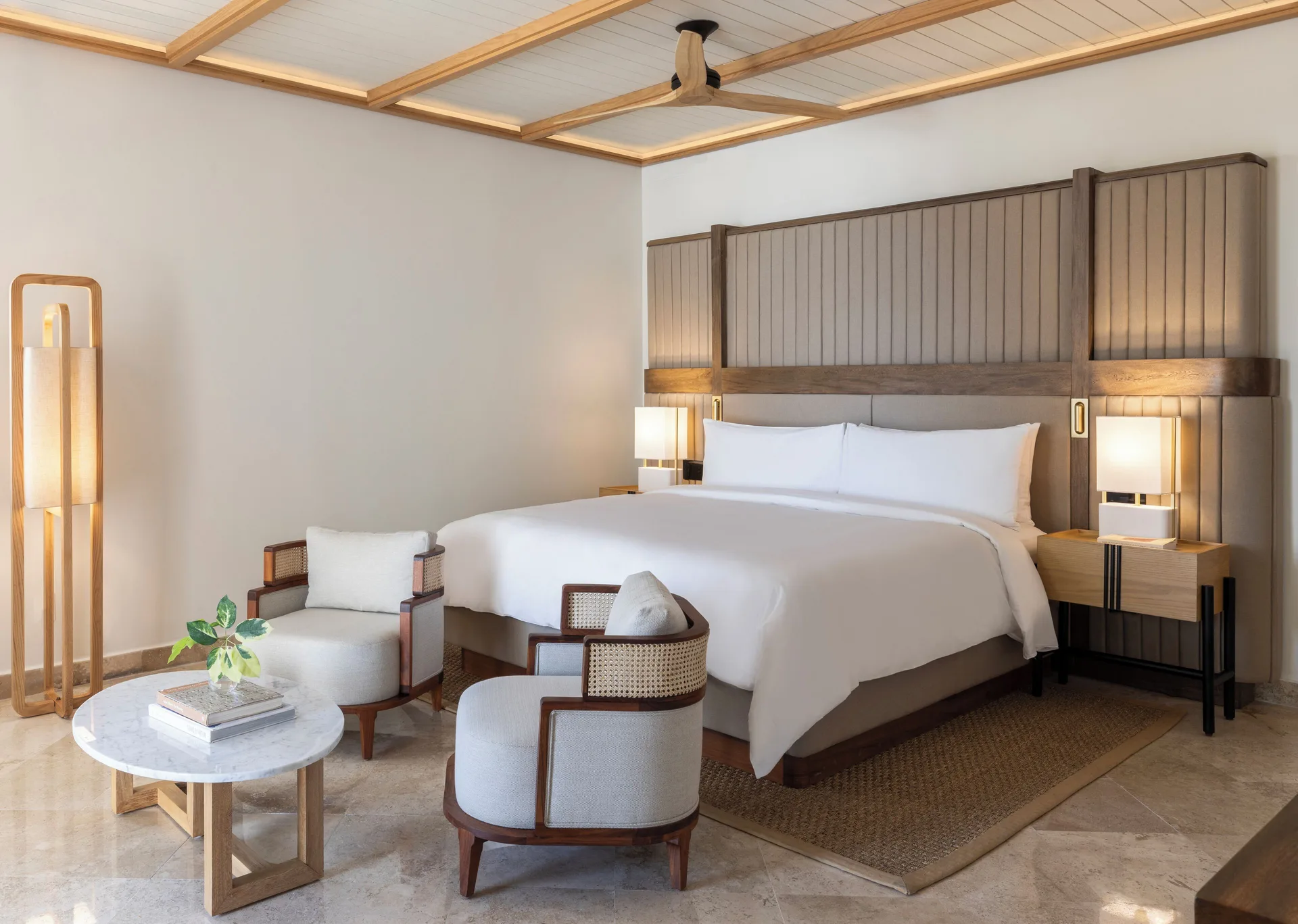 Beachfront casita bedroom with king bed and sitting chairs at Fairmont Mayakoba.