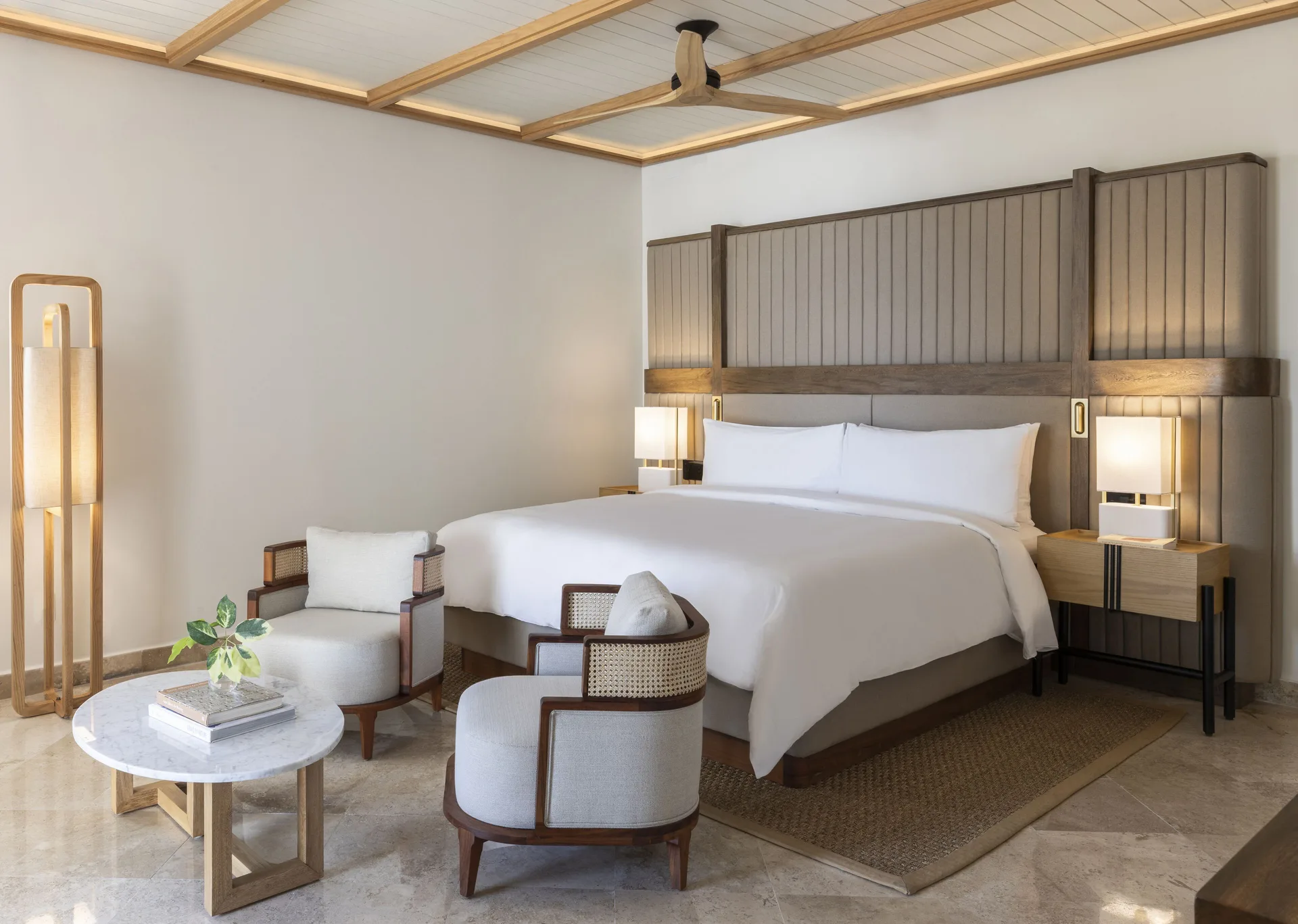 Beachfront casita bedroom with king bed and sitting area at Fairmont Mayakoba.
