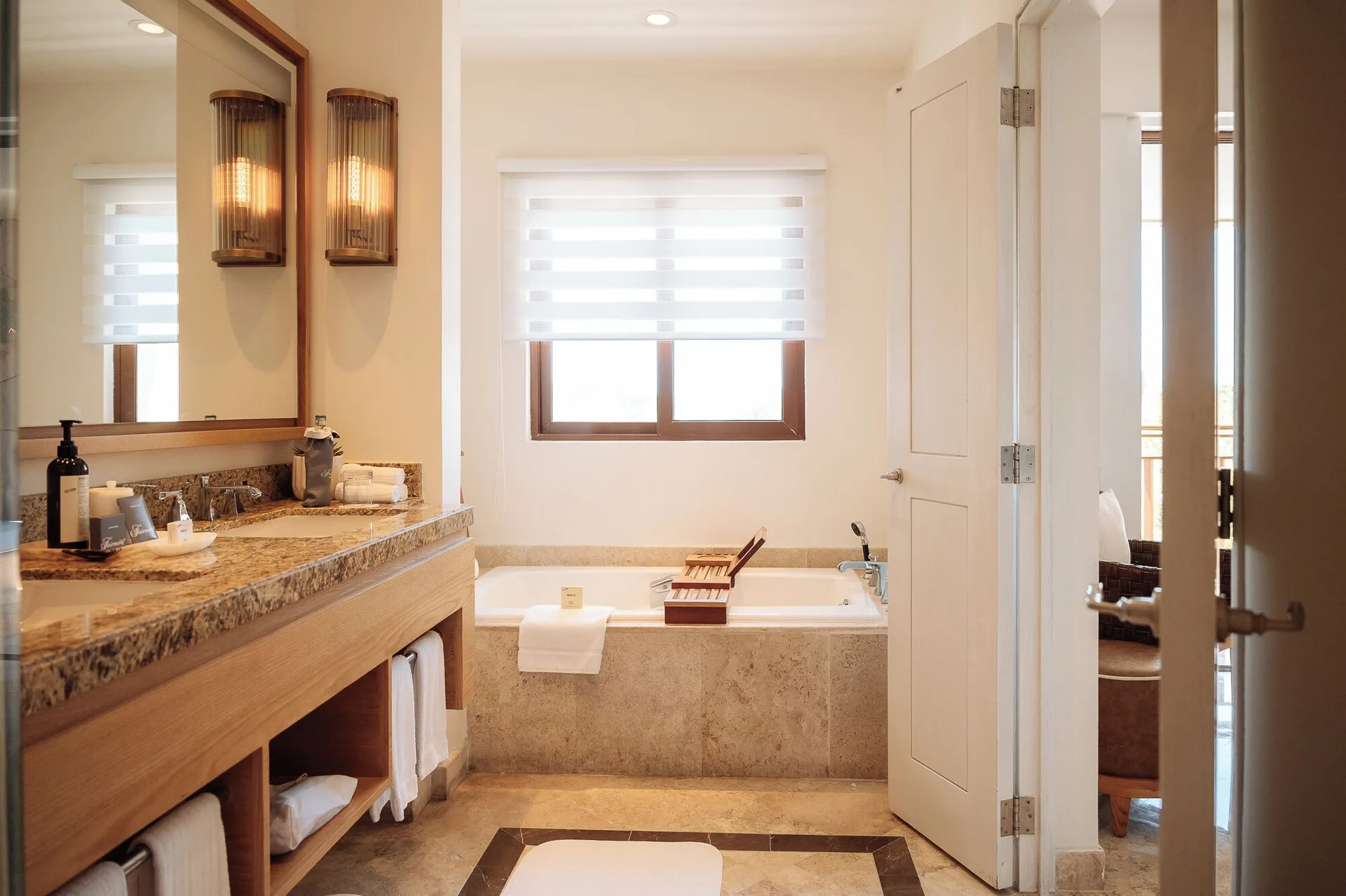 Bathroom with granite vanity and soaking tub in a room at Fairmont Mayakoba.