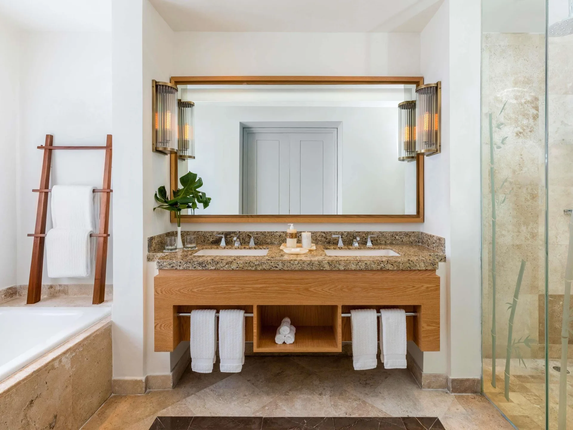 Double vanity, bathtub, and glass shower in a Family Room bathroom at Fairmont Mayakoba.