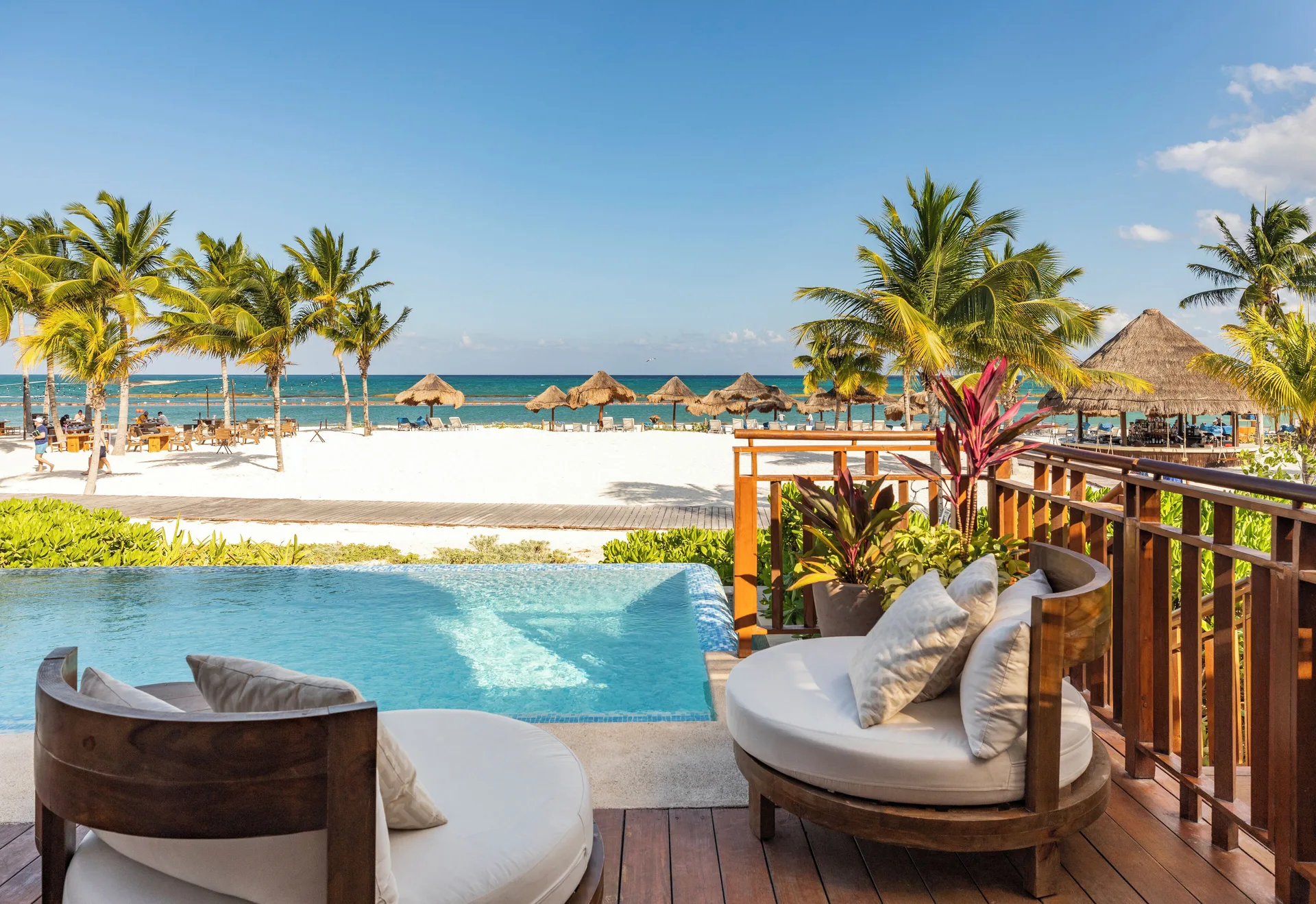 Premium Suite beachfront terrace loungers beside a pool and ocean view at Fairmont Mayakoba.
