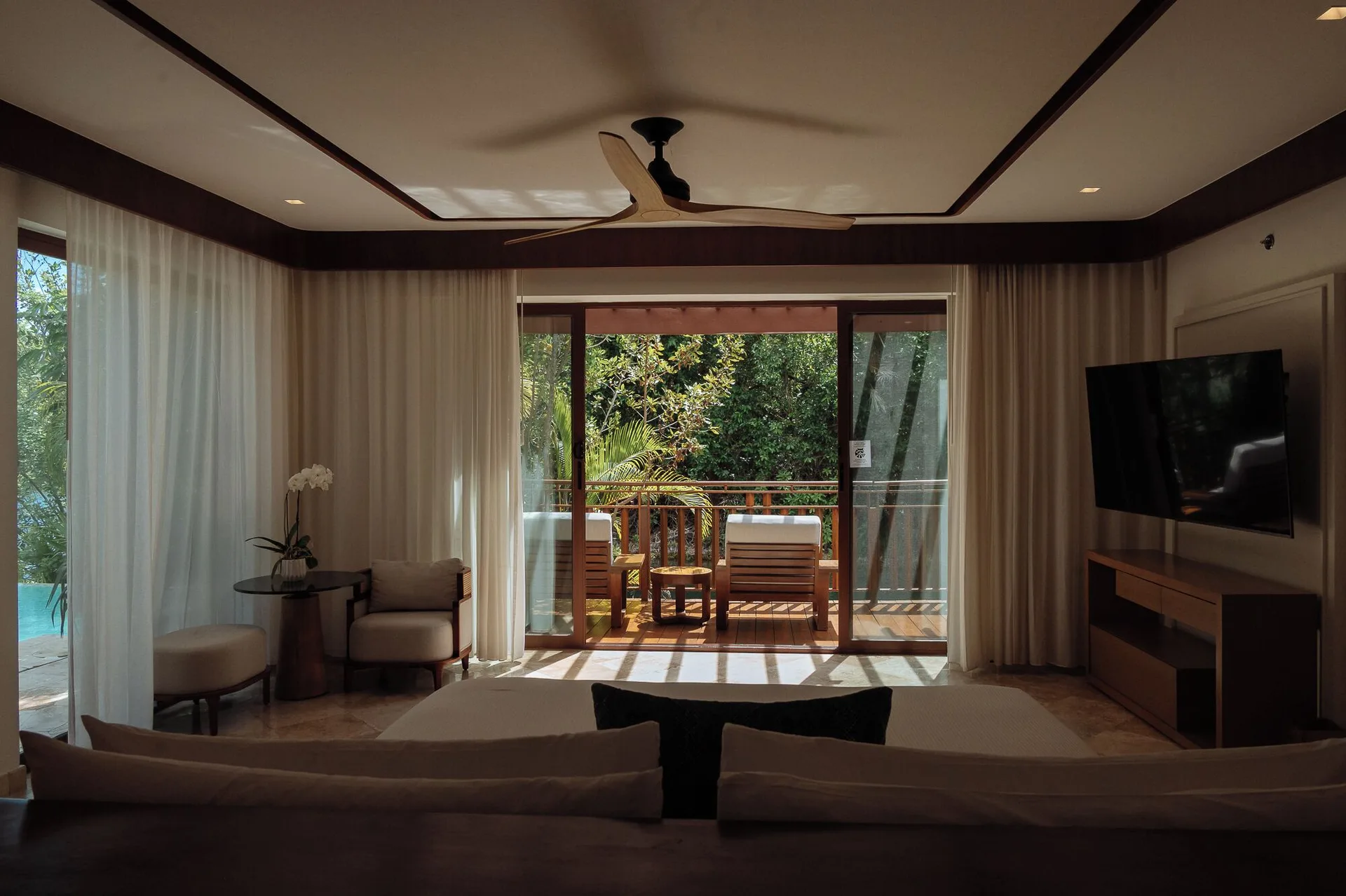 Presidential Suite bedroom with balcony and TV at Fairmont Mayakoba.