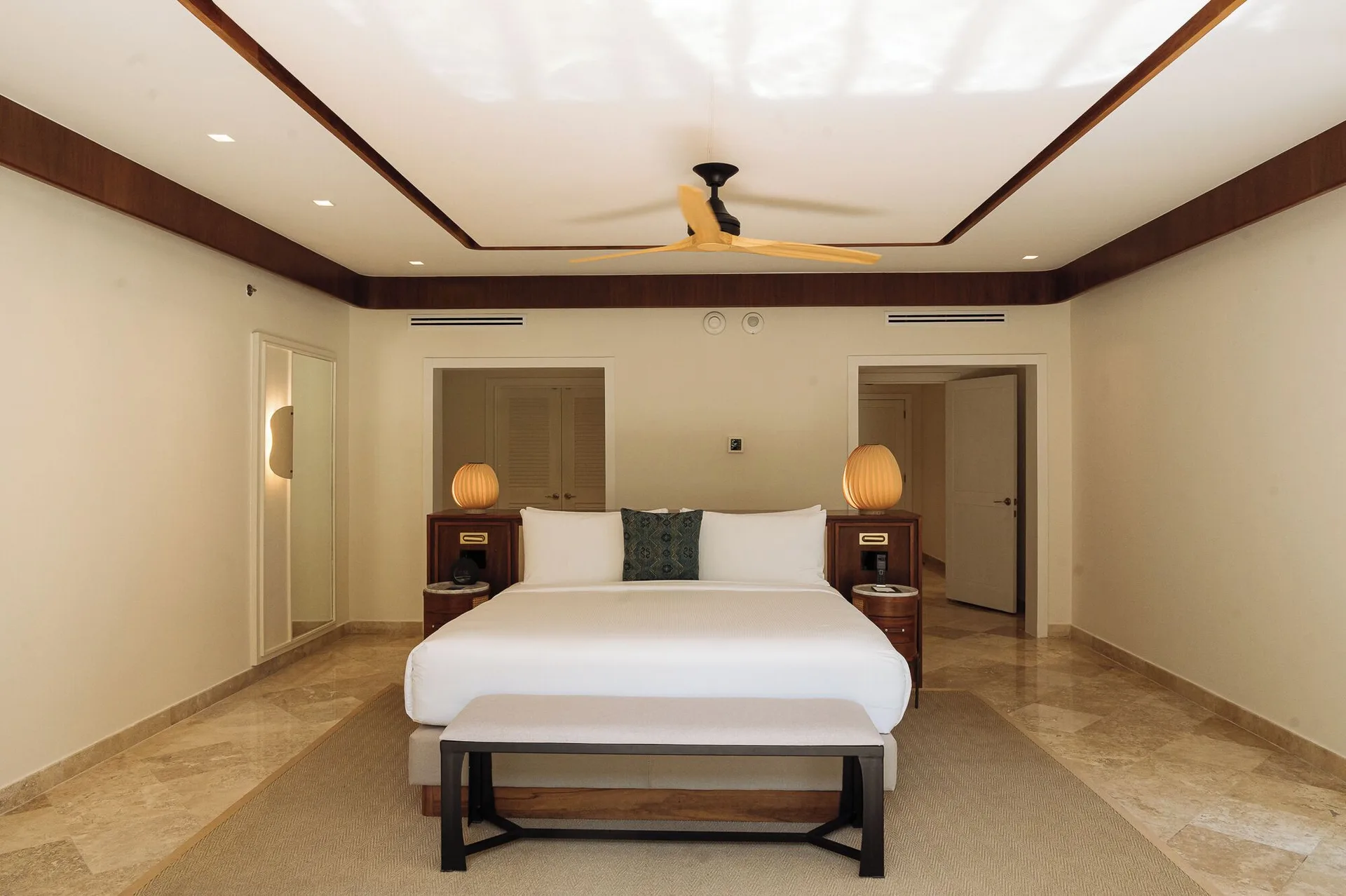 Presidential Suite king bedroom with bench and lamps at Fairmont Mayakoba.