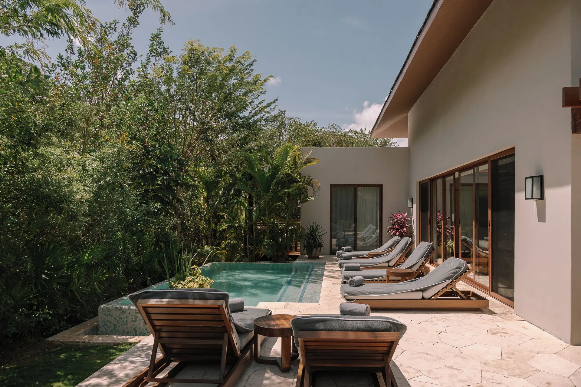 Presidential Suite pool terrace with multiple loungers at Fairmont Mayakoba.